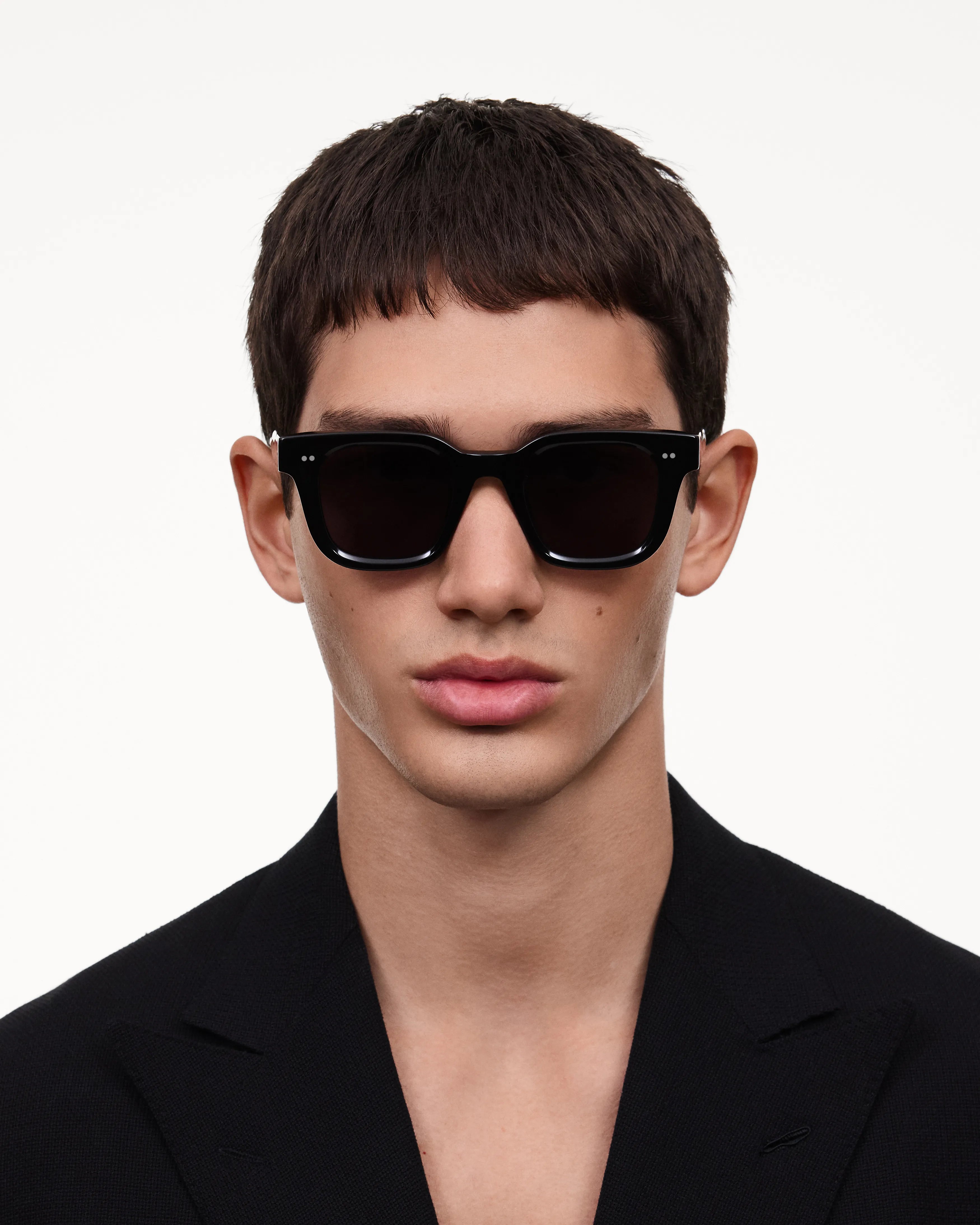 Model wearing 04 Core Black Sunglasses with anti-scratch lenses and durable Acetate Renew™ material.
