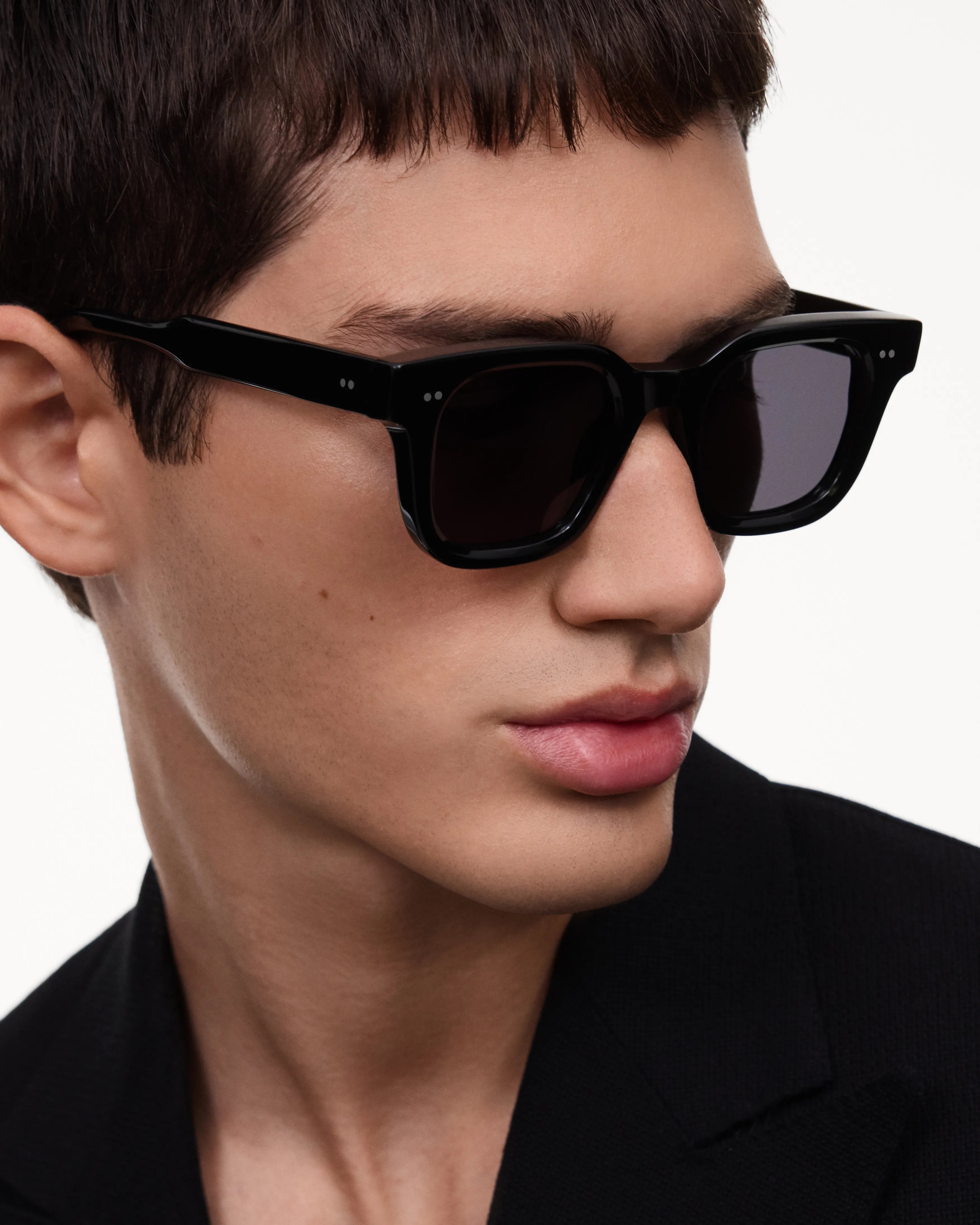 04 Core Black Sunglasses worn by a model, featuring durable Acetate design and anti-scratch lenses.