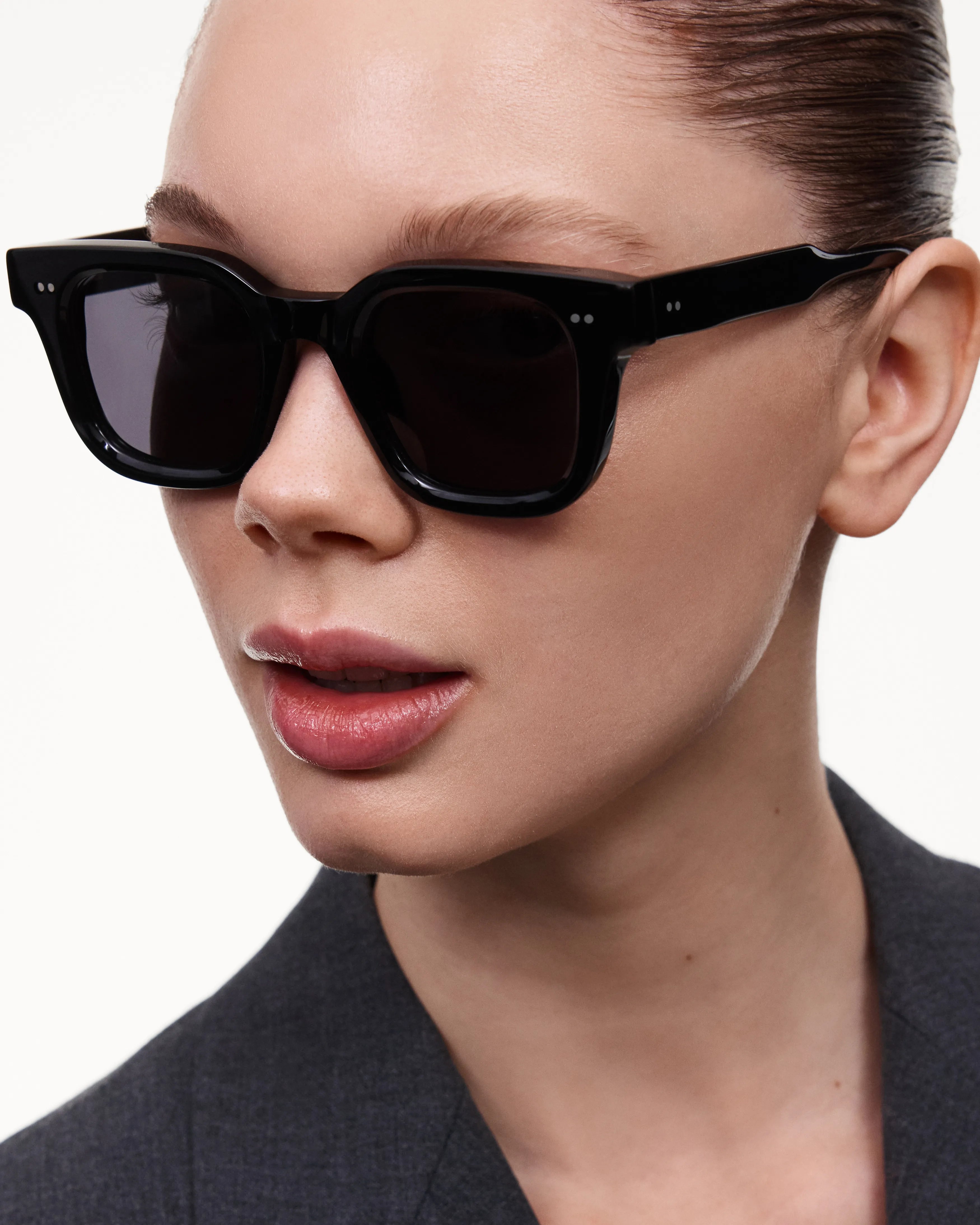 04 Core Black Sunglasses worn by a model, showcasing stylish unisex design and dark lenses for UV protection.