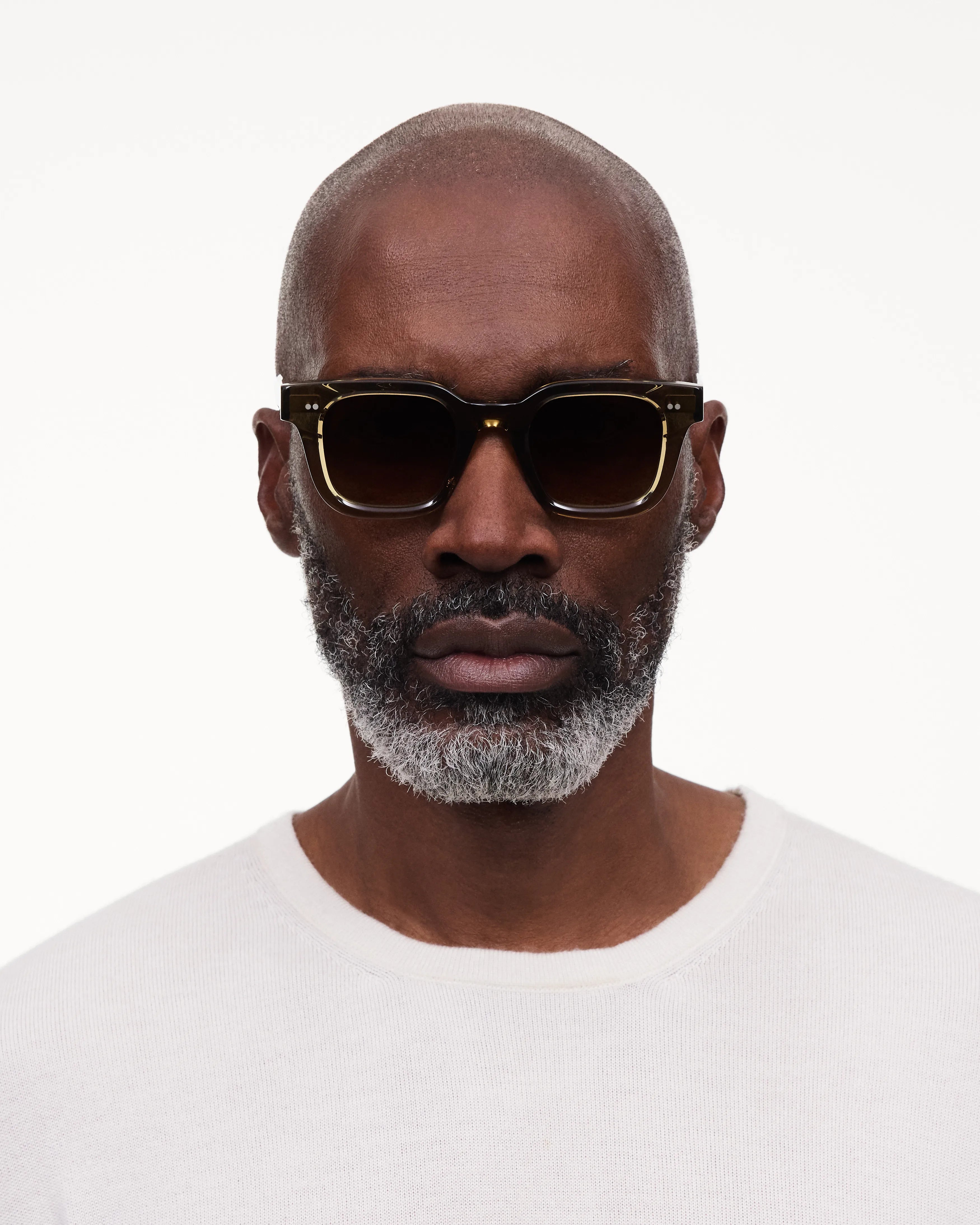 Man wearing 04 Core Green Sunglasses, featuring durable Acetate Renew™ material and anti-scratch lenses.