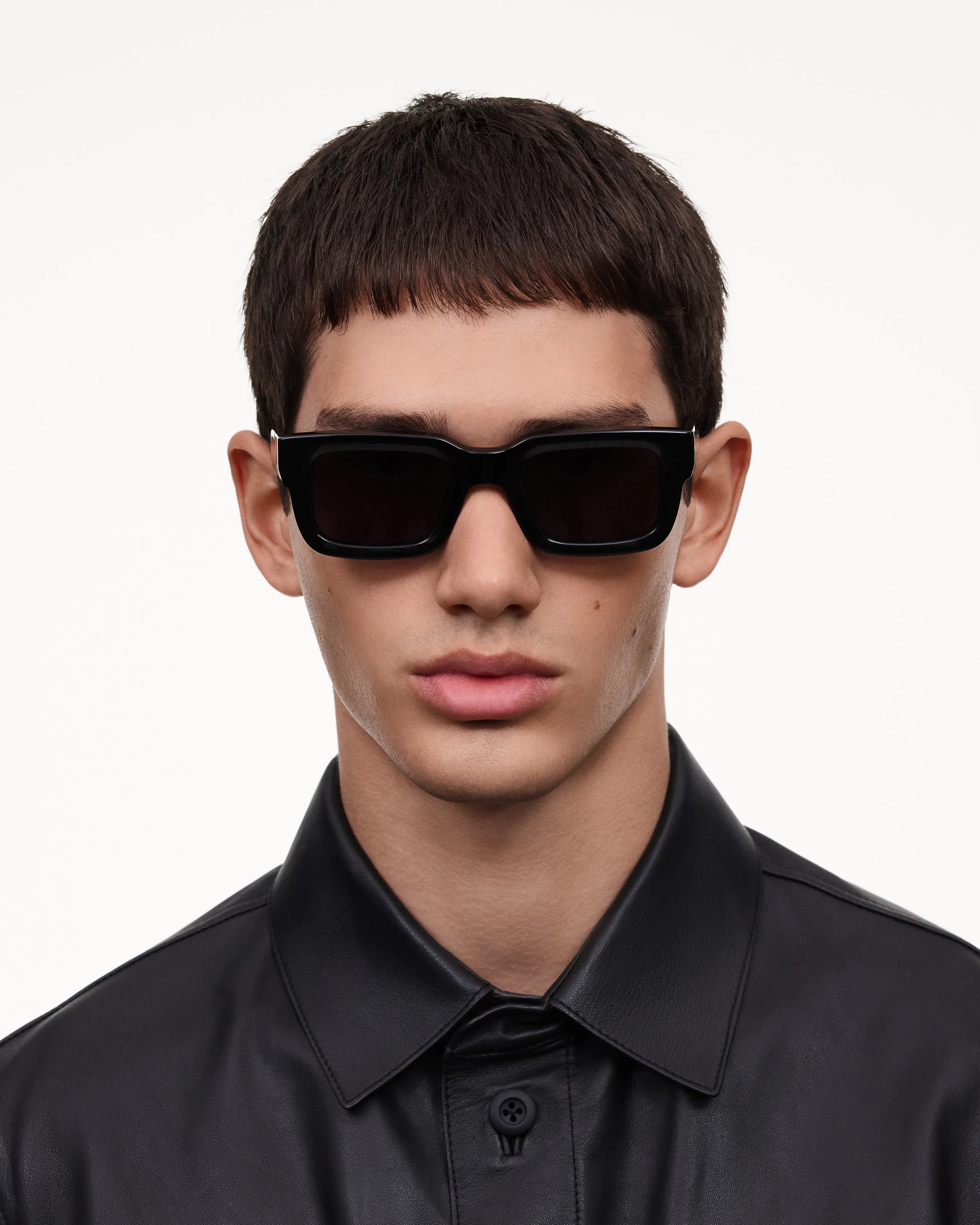 Model wearing 05 Core Black Sunglasses with unisex design and high-quality features.