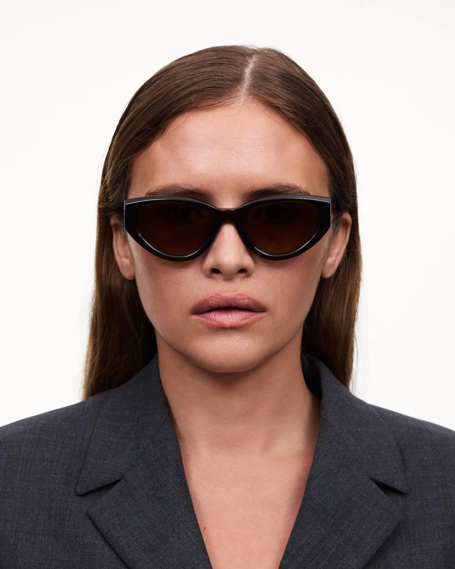 Woman wearing 06 Core Brown Sunglasses with stylish black frame and dark lenses.