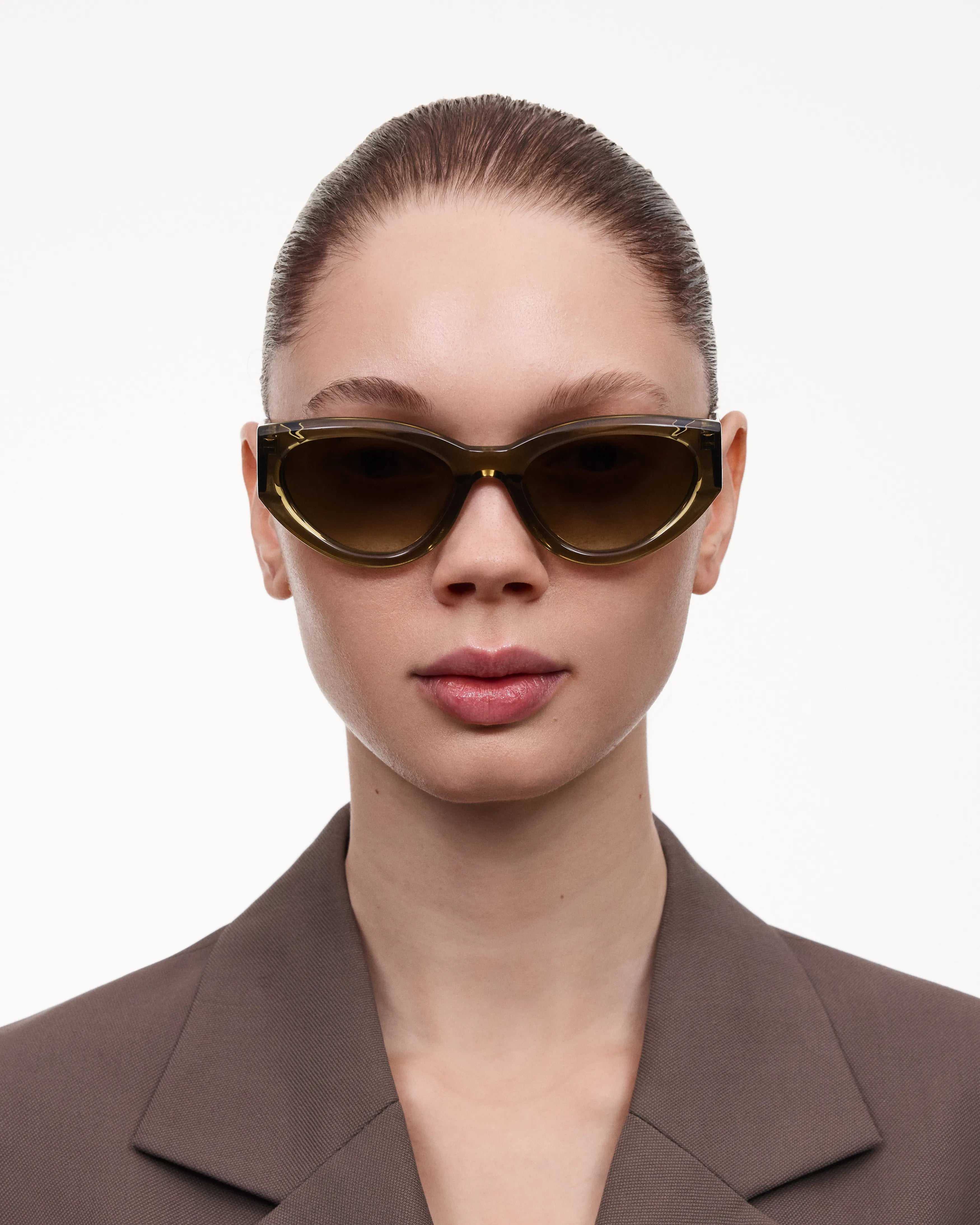 Model wearing 06 Core Green Sunglasses with a chic outfit.