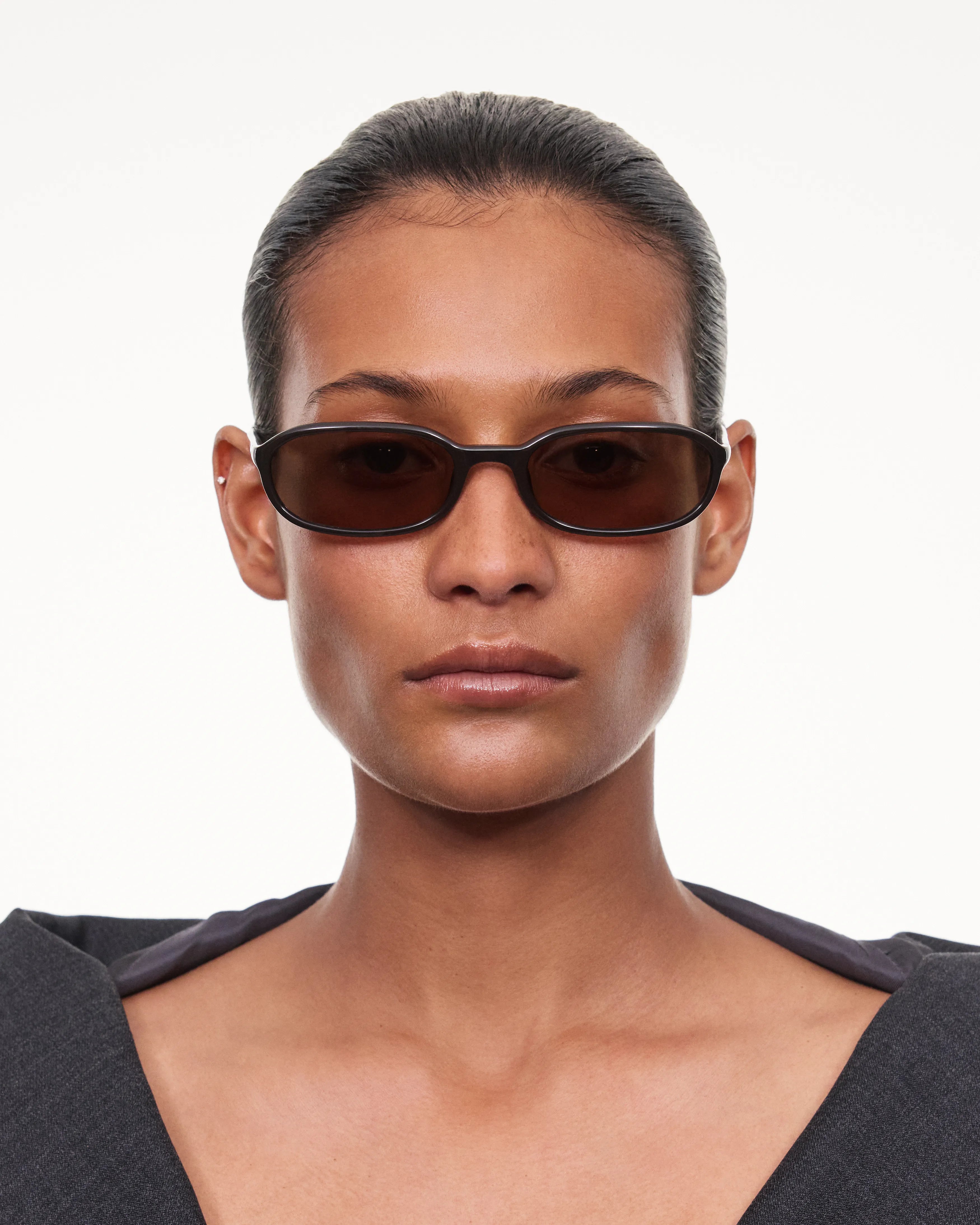 Model wearing Edith Dark Brown Sunglasses, showcasing stylish design and perfect fit for small to medium heads.