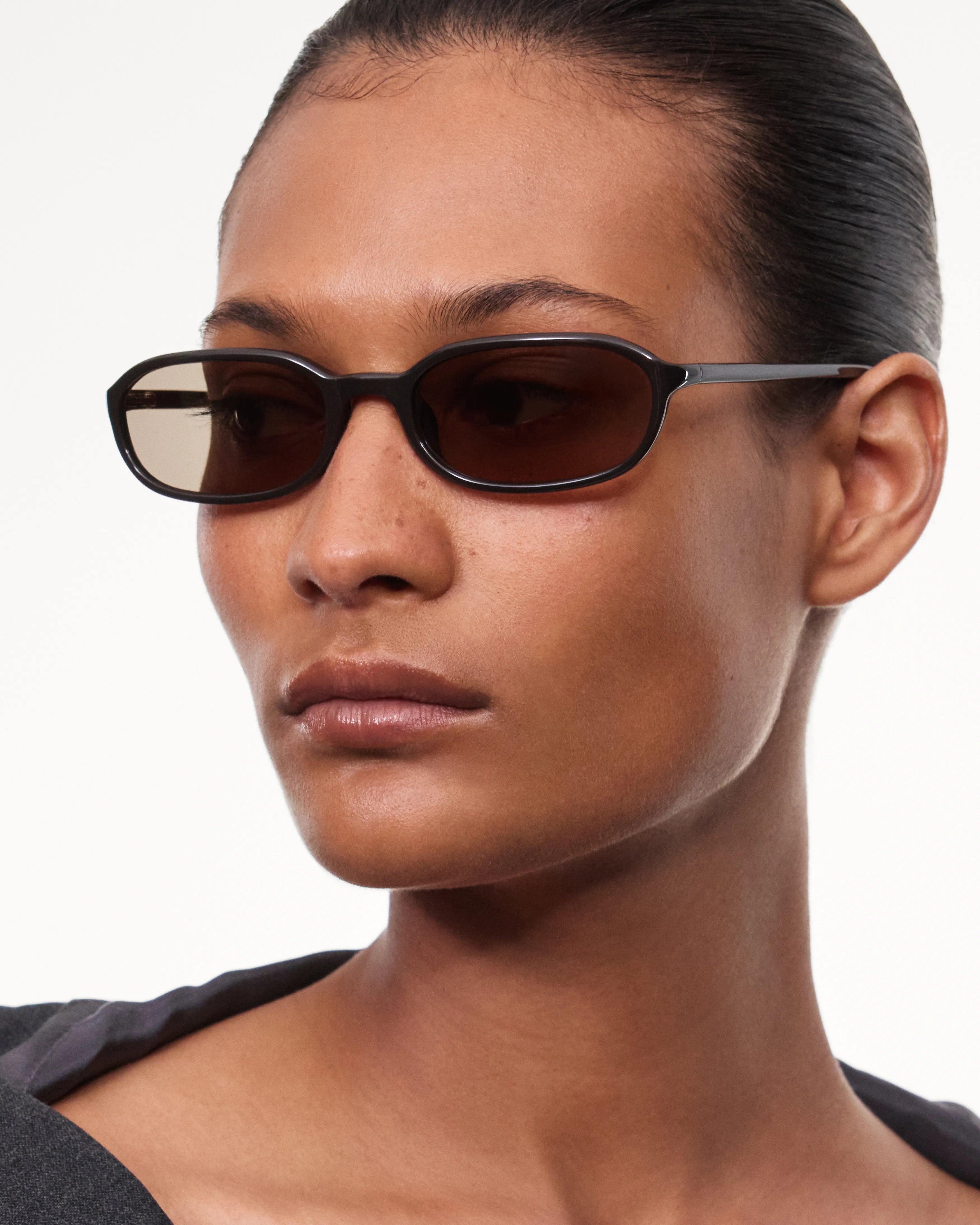 Model wearing Edith Dark Brown Sunglasses with stylish design and comfortable fit, showcasing UVA + UVB protection.