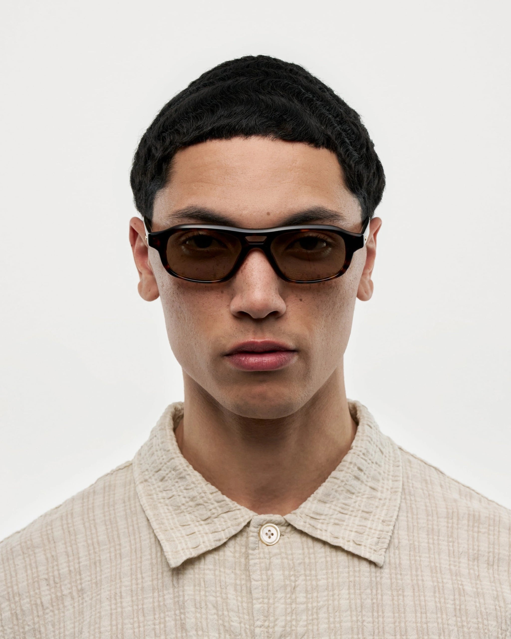 Eli Terra Tortoise Sunglasses worn by a model, showcasing style and durability.