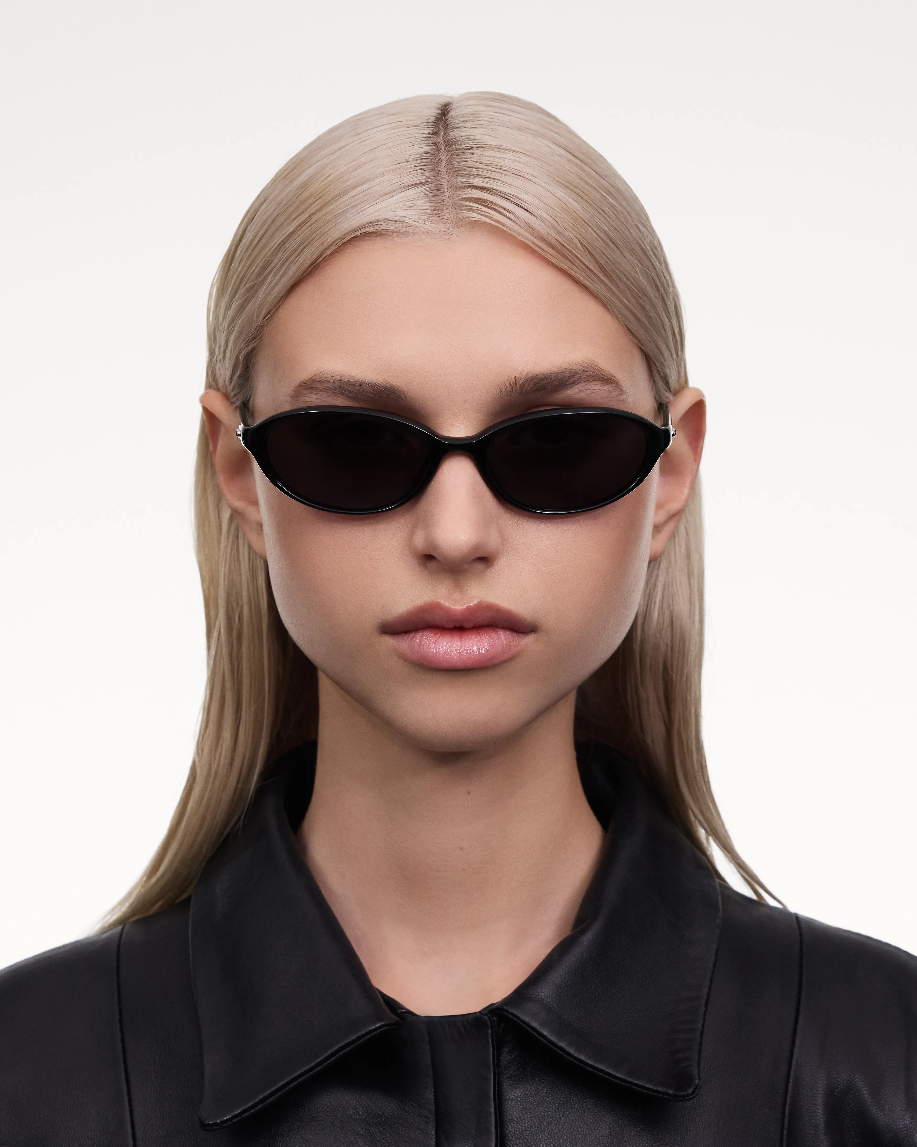 Ellipse Black Sunglasses worn by a model with long hair, featuring a stylish black frame and sleek design.