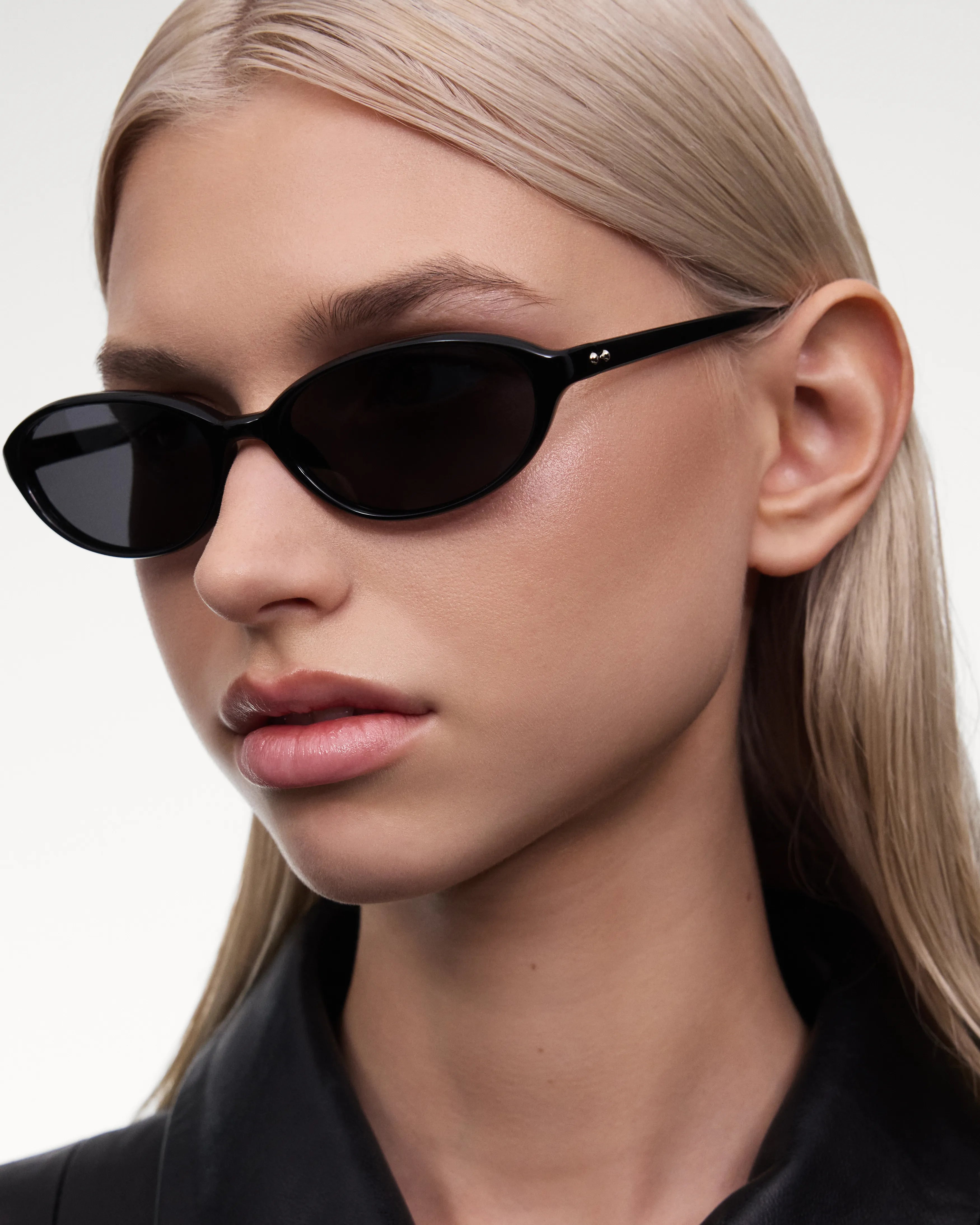 Ellipse Black Sunglasses worn by a model, featuring sleek design and dark lenses.