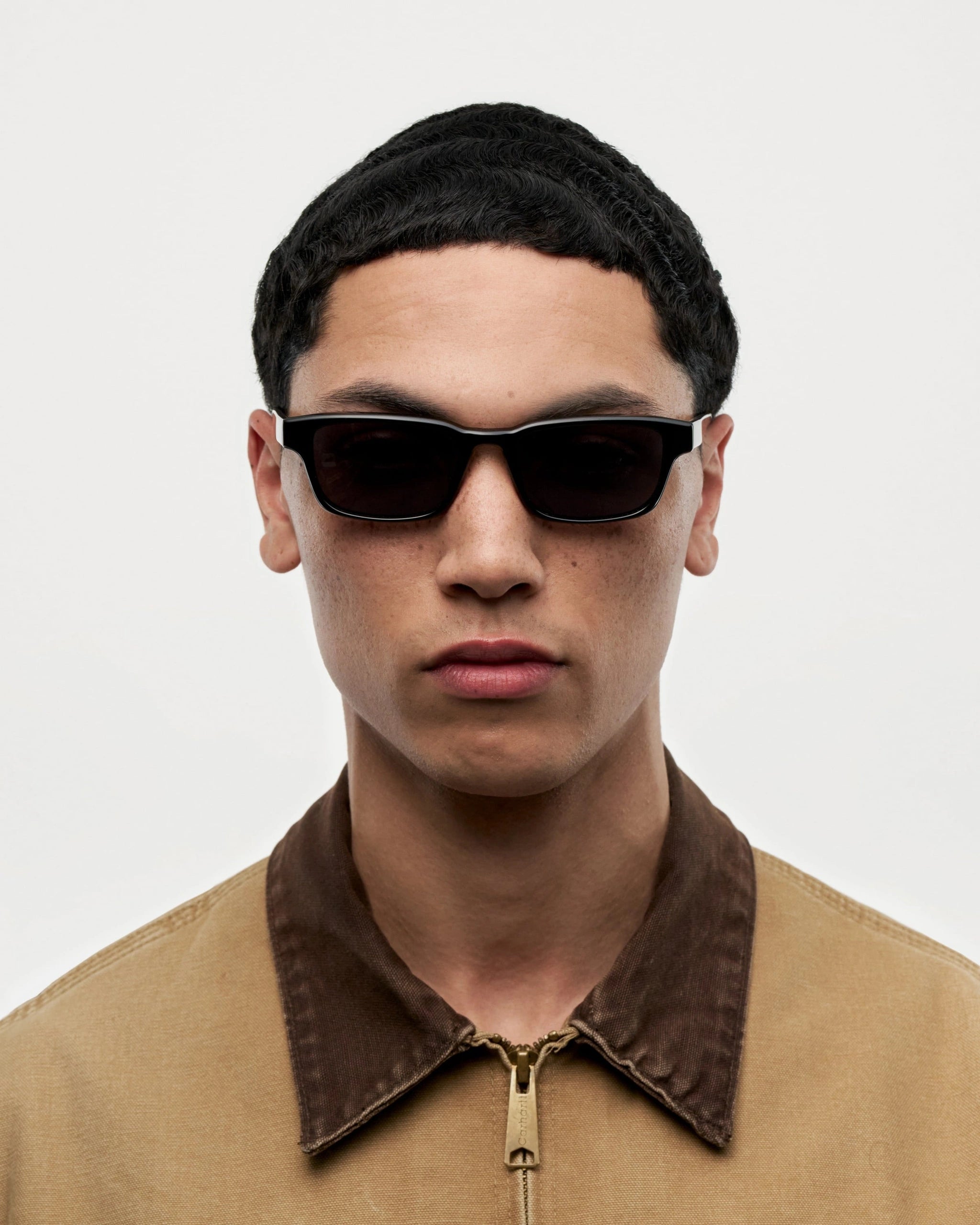 Model wearing Kasi Black Sunglasses, showcasing stylish black design and modern aesthetic.