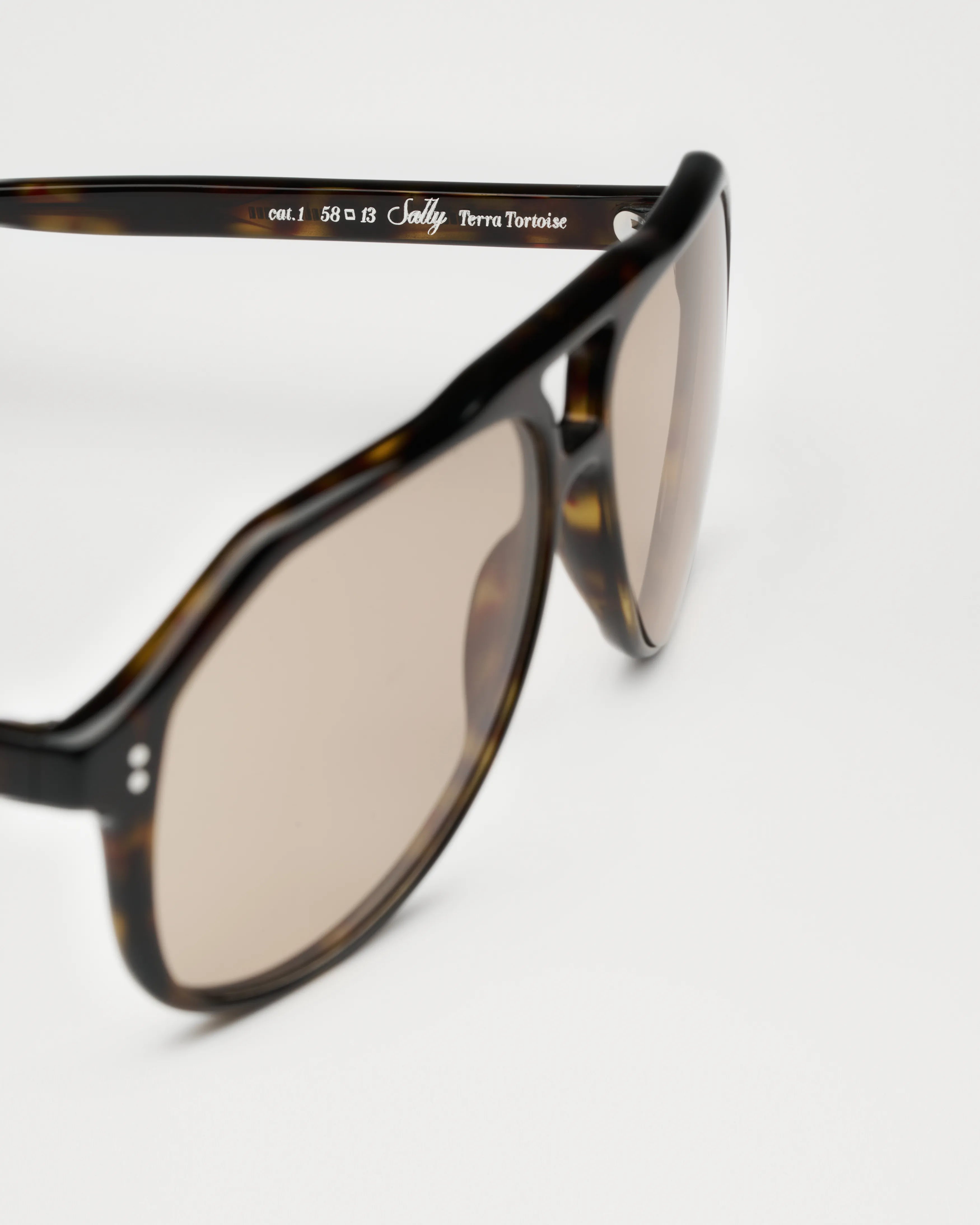 Sally Terra Tortoise Sunglasses featured at an angle showing their stylish design and lenses.
