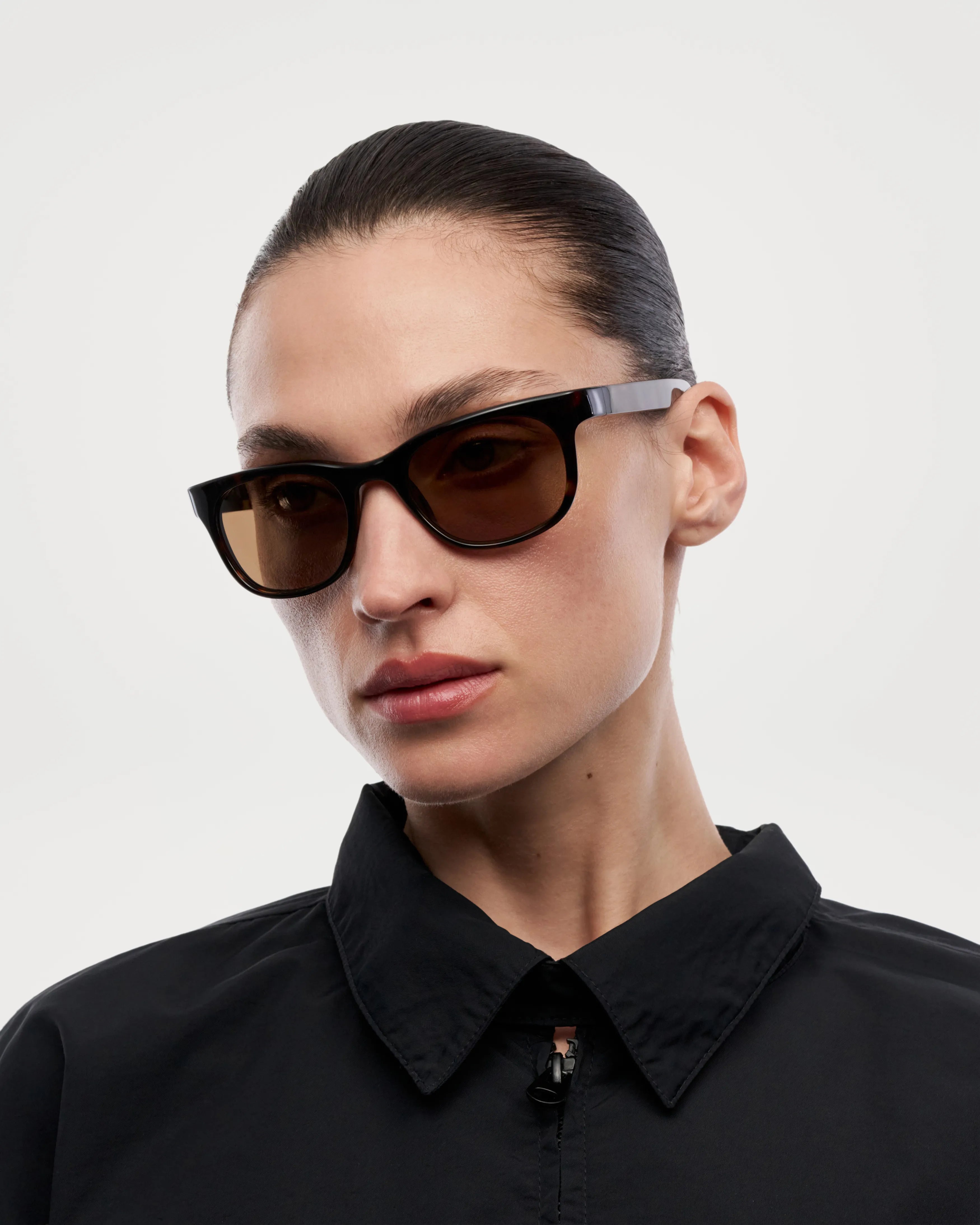 Savy Tortoise Sunglasses worn by model, featuring stylish design and 100% UVA + UVB protection.
