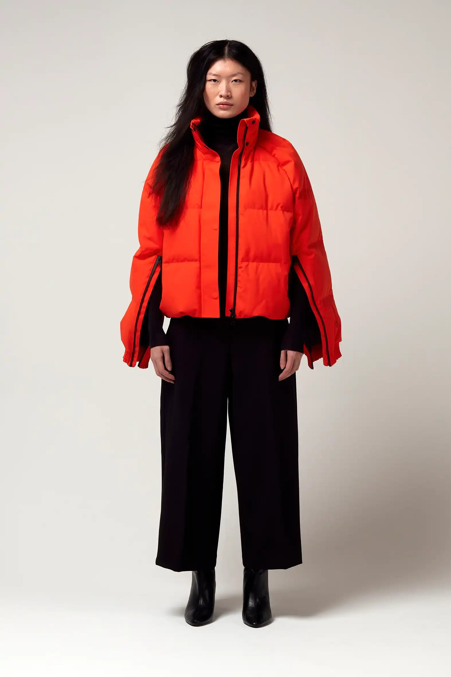 Model wearing Agasga Poppin Red Coat, a waterproof and lightweight jacket with innovative features.