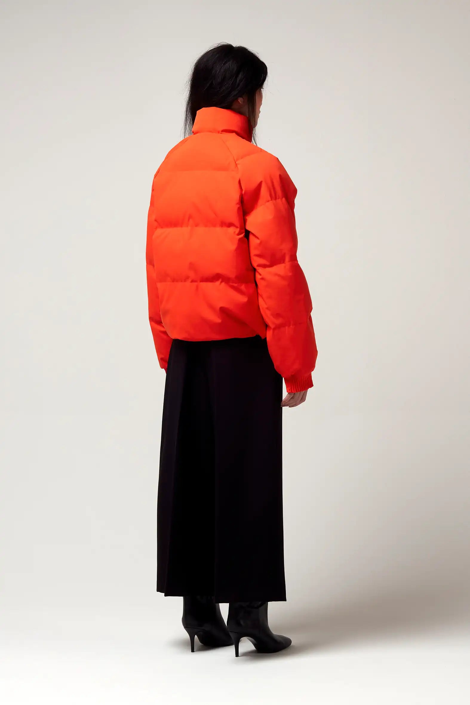 Model wearing Agasga Poppin Red Coat, showcasing its vibrant red color and stylish design.