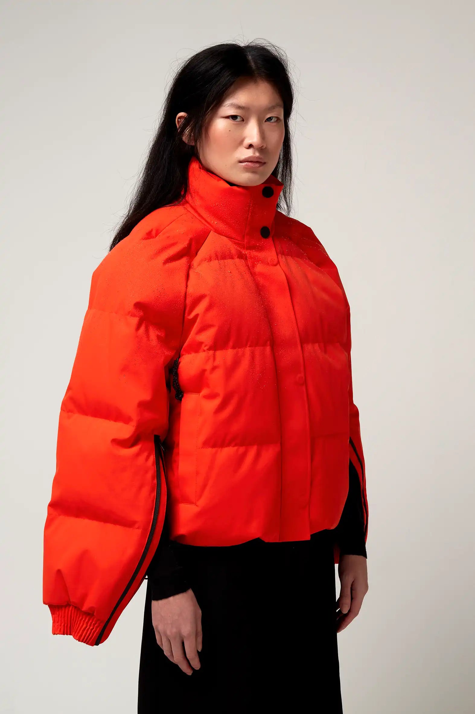 Agasga Poppin Red Coat model showcases vibrant red color with unique padded design and stylish features.