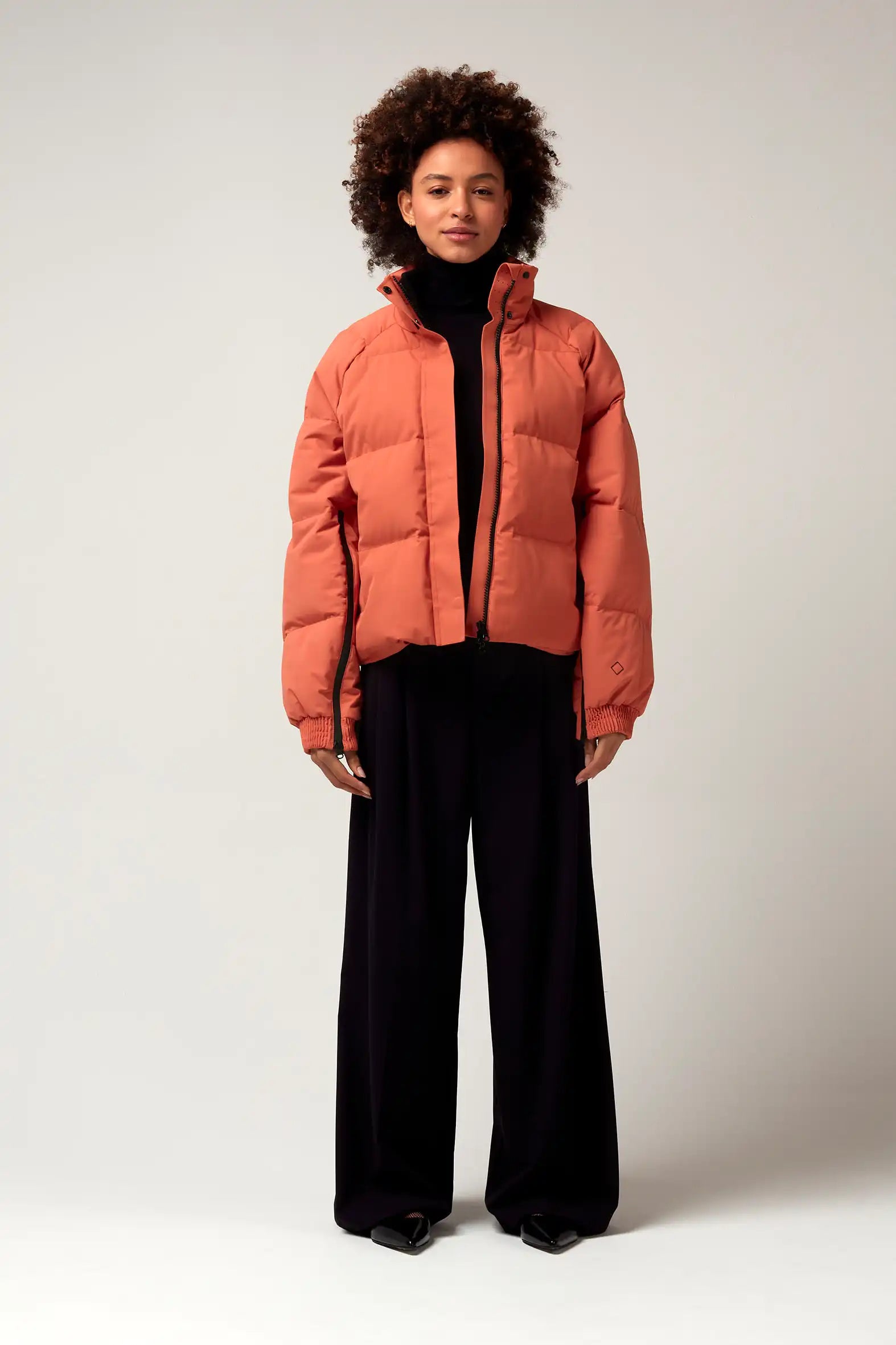 Model wearing the Agasga Apricot Coat, a lightweight waterproof jacket with a stylish design.