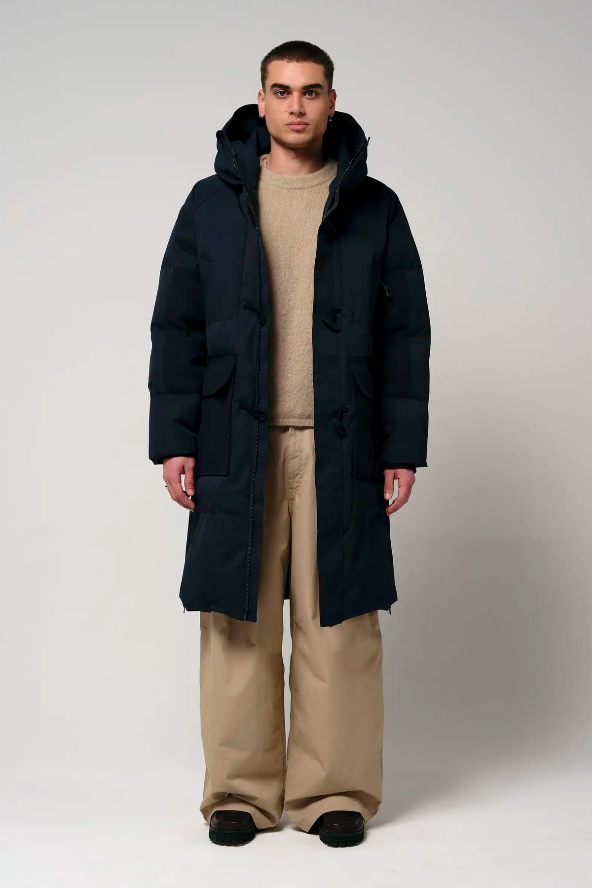 Barack Sky Captain Blue Parka, model wearing a warm, waterproof coat with adjustable hood and reflective strip.