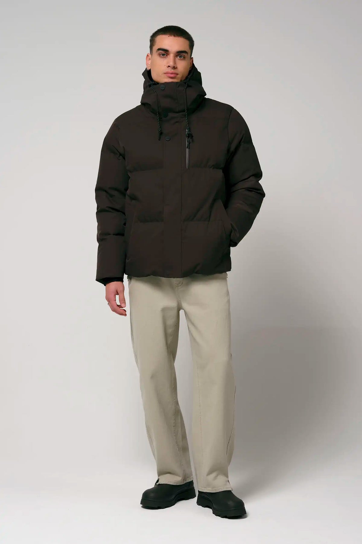 Bayu Black Coffee Coat worn by male model, showcasing waterproof and breathable design with puffer jacket style.