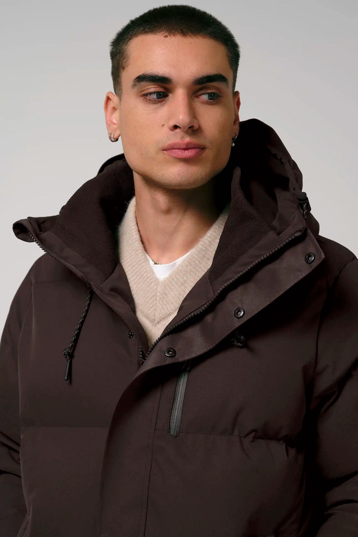 Model wearing the Bayu Black Coffee Coat in brown, showcasing its stylish design and functional features.