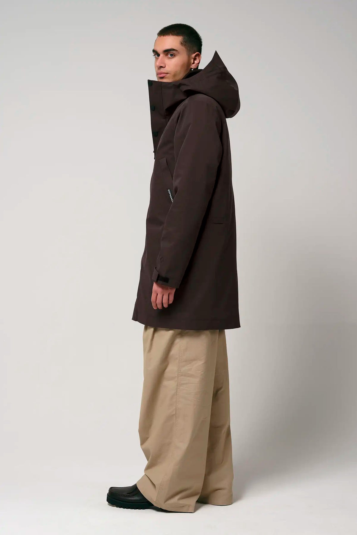 Model wearing Cielo Black Coffee Coat, showcasing its waterproof and breathable features.