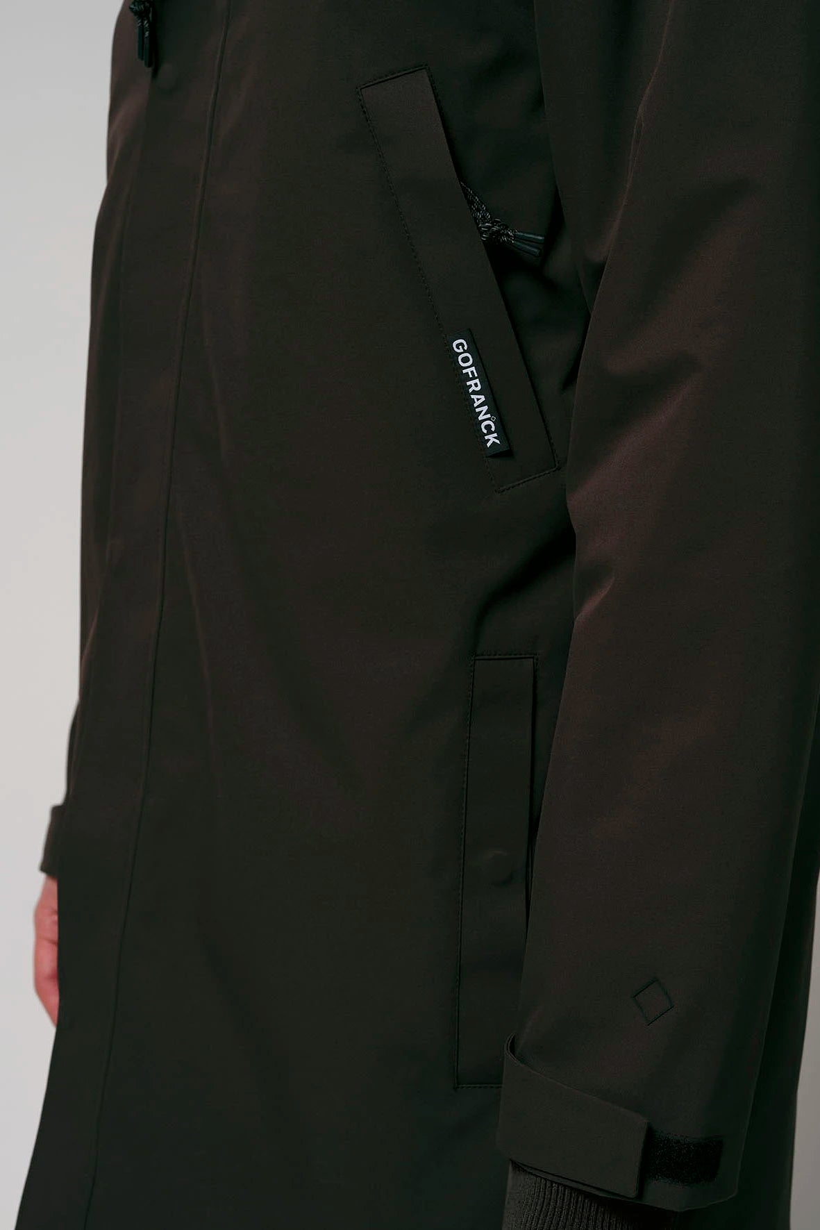 Cielo Black Coffee Coat close-up showing design details and pocket features in waterproof material.