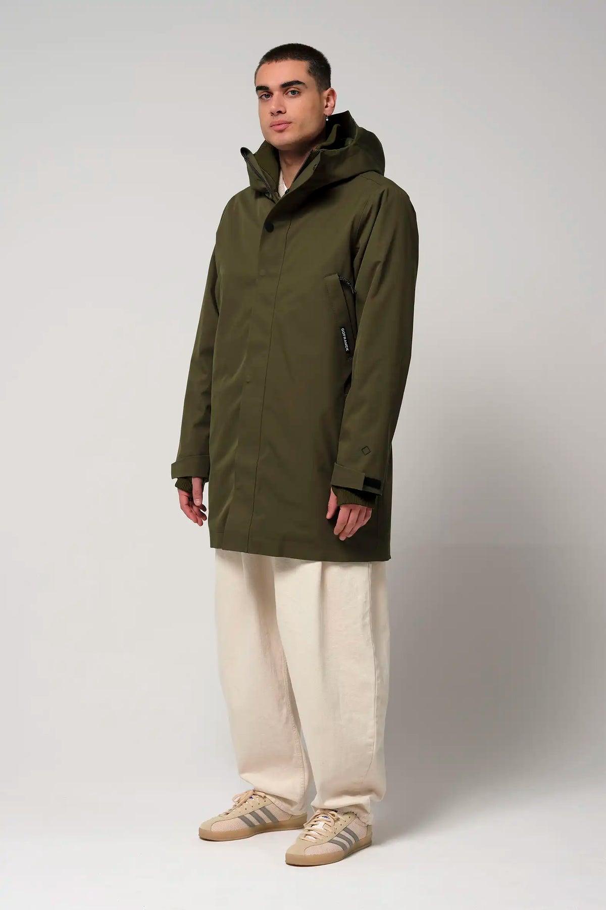 Model wearing Cielo Dark Olive Green Coat, showcasing its waterproof, windproof features and modern design.