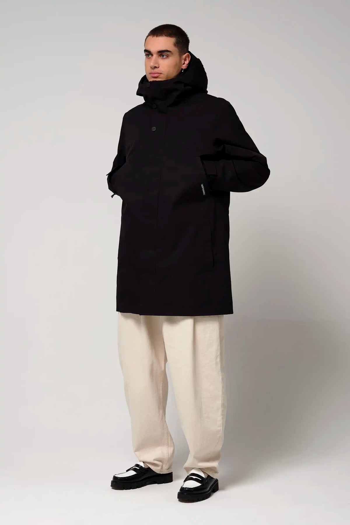 Model wearing the Cielo Deep Black Coat, showcasing its waterproof and windproof features.