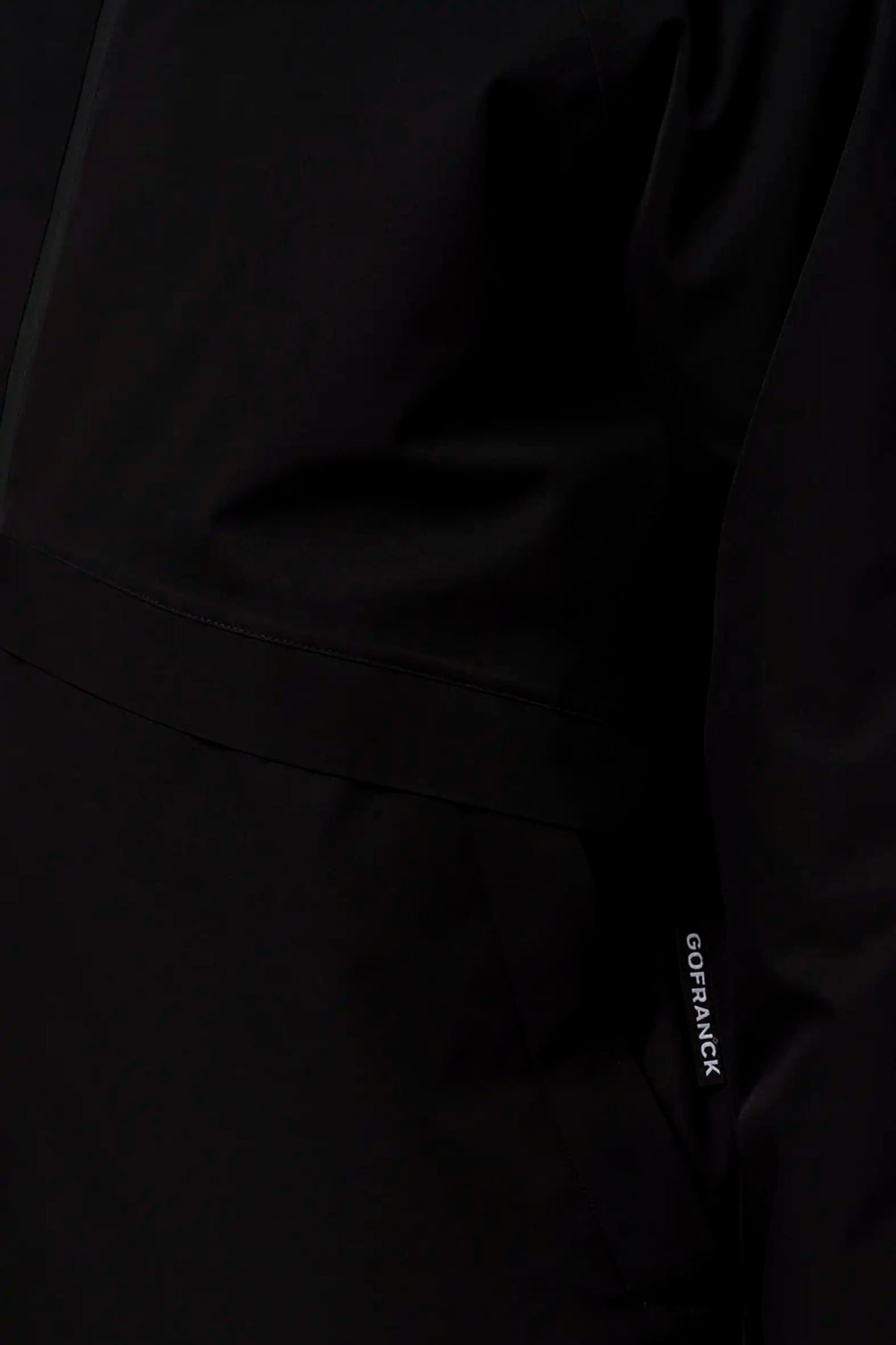 Claud Deep Black Coat showcasing its waterproof and windproof features with fully taped seams.