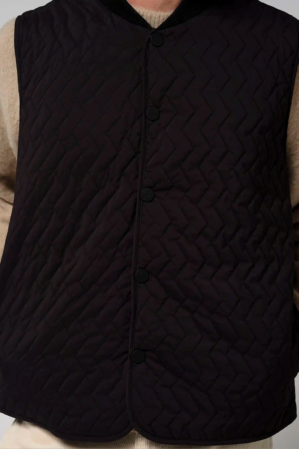 Claud Deep Black Coat, a stylish garment featuring a quilted design for warmth and comfort in cooler seasons.