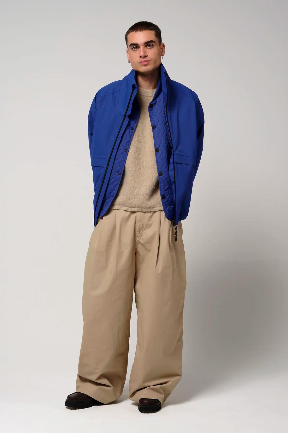 Man wearing Claud Sodalite Blue Coat with beige pants, showcasing a stylish fall outfit.