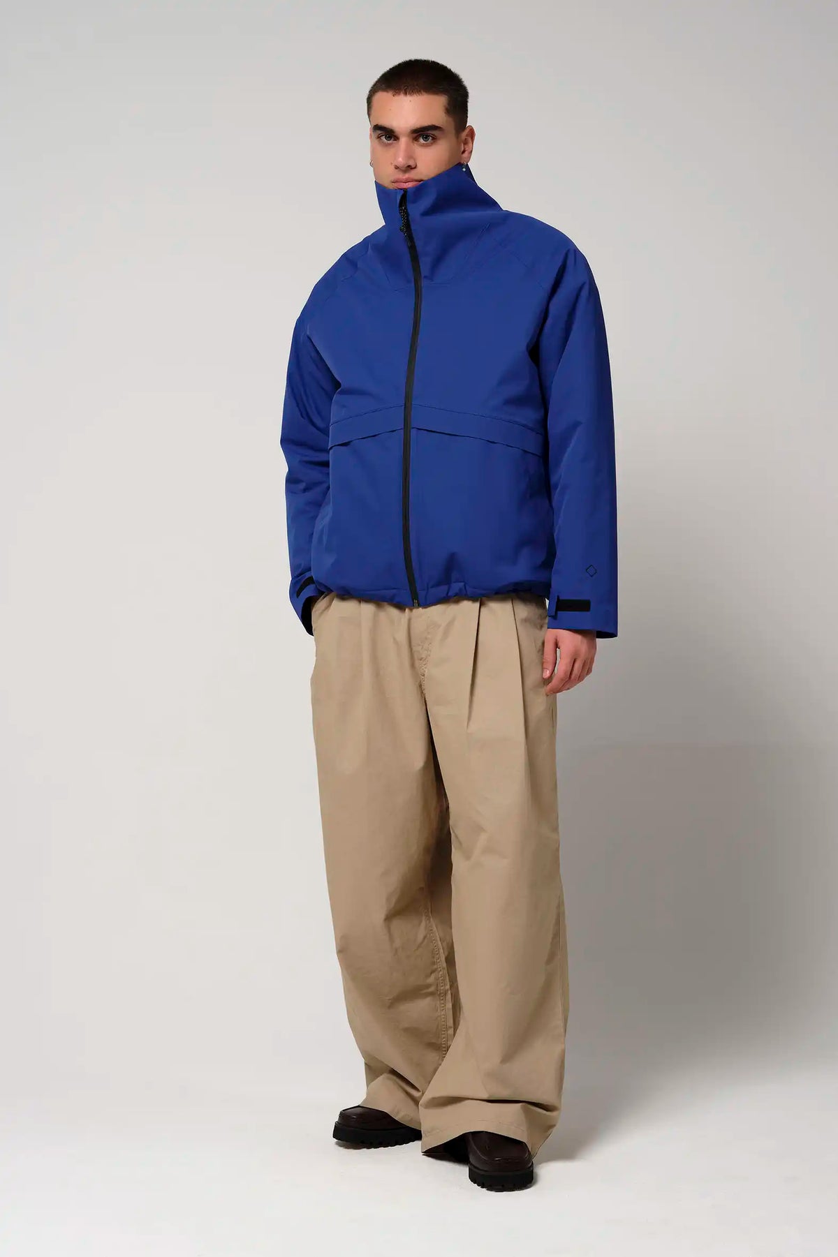 Model wearing Claud Sodalite Blue Coat, a waterproof 3-in-1 jacket ideal for fall, winter, and spring.