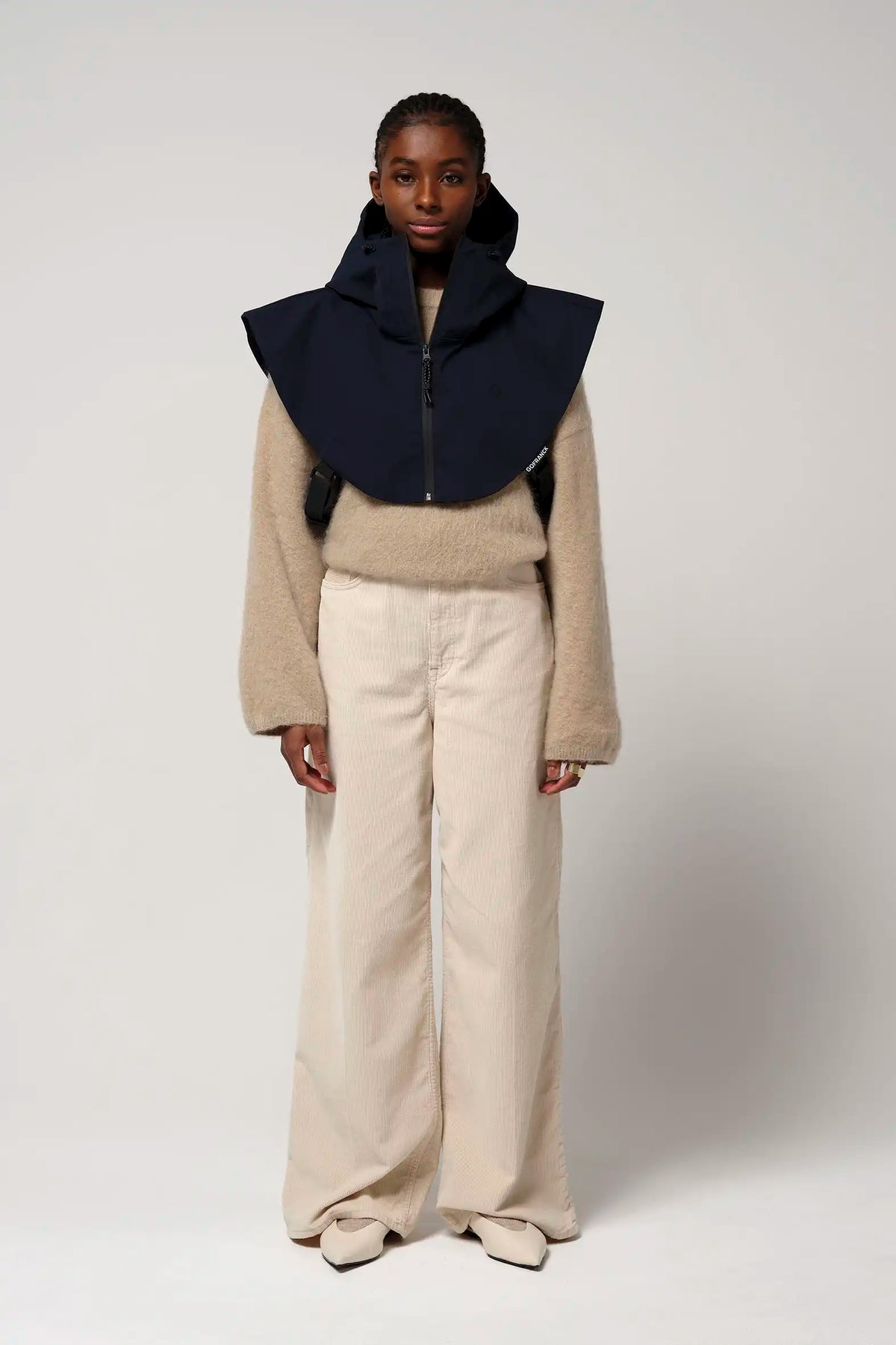 Gale Sky Captain Blue Parka worn with a beige sweater and light pants against a neutral background.