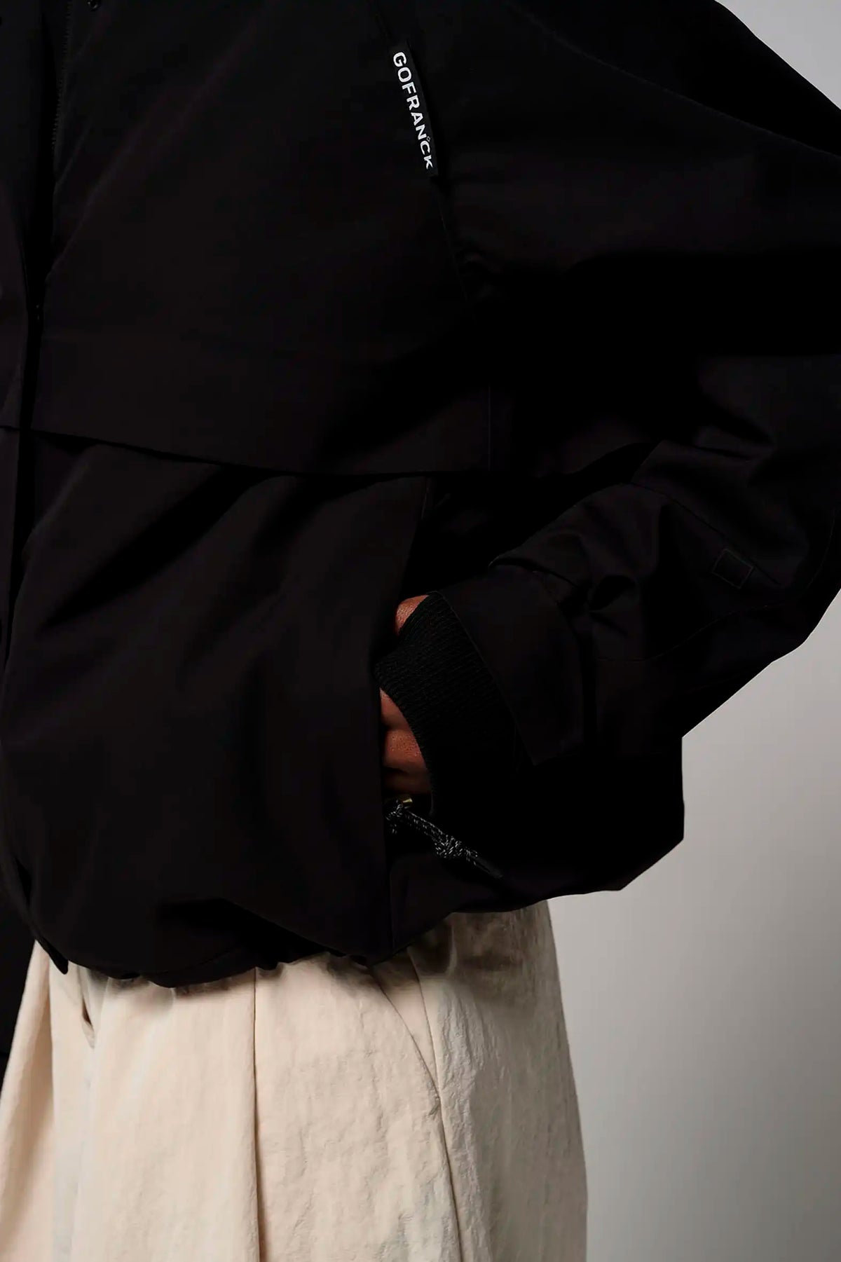 Guthrie Deep Black Coat featuring a close-up of pockets and adjustable cuffs in a stylish black design.