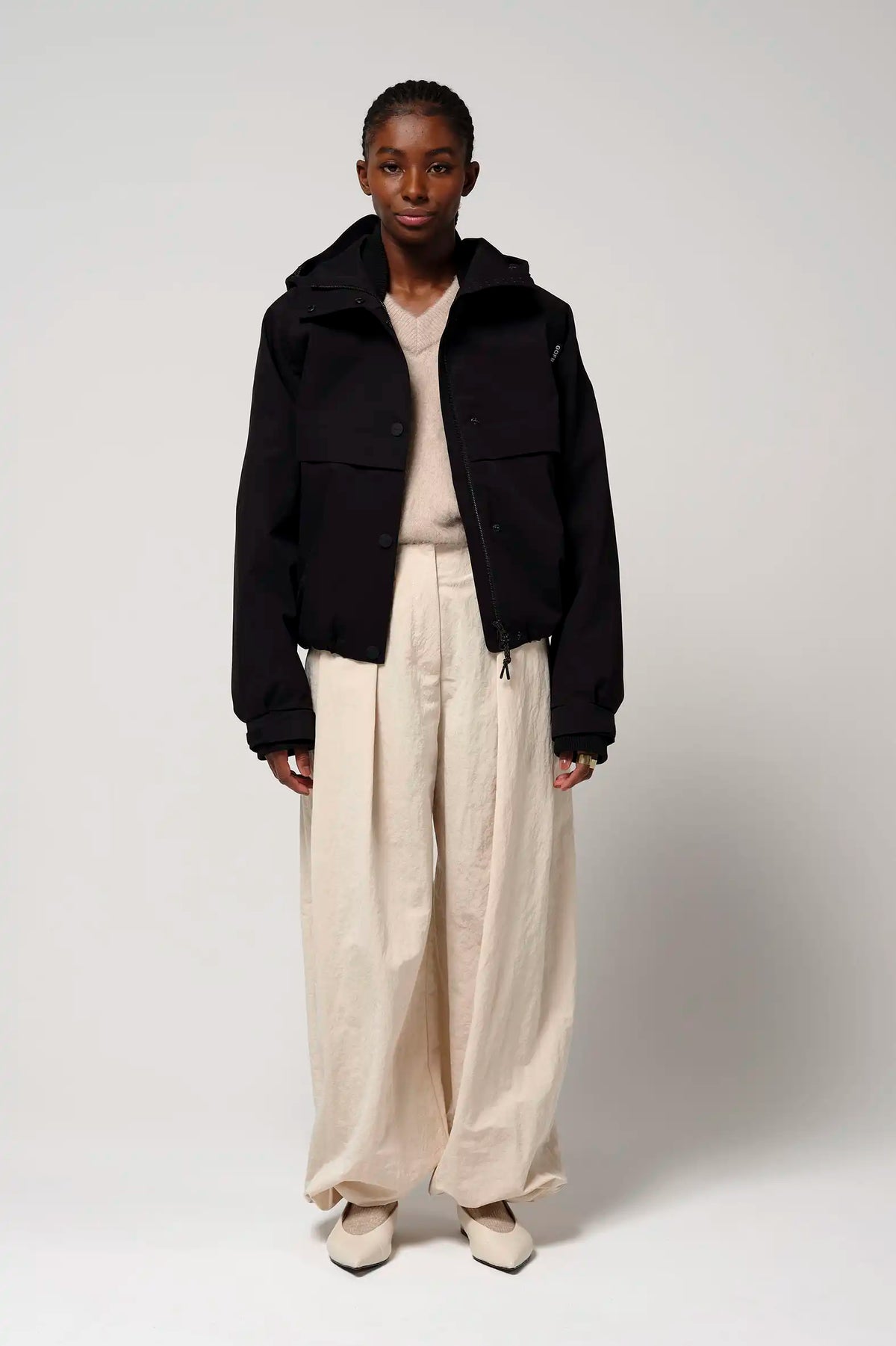 Guthrie Deep Black Coat worn by a model with a layered outfit, showcasing its stylish design and practical features.