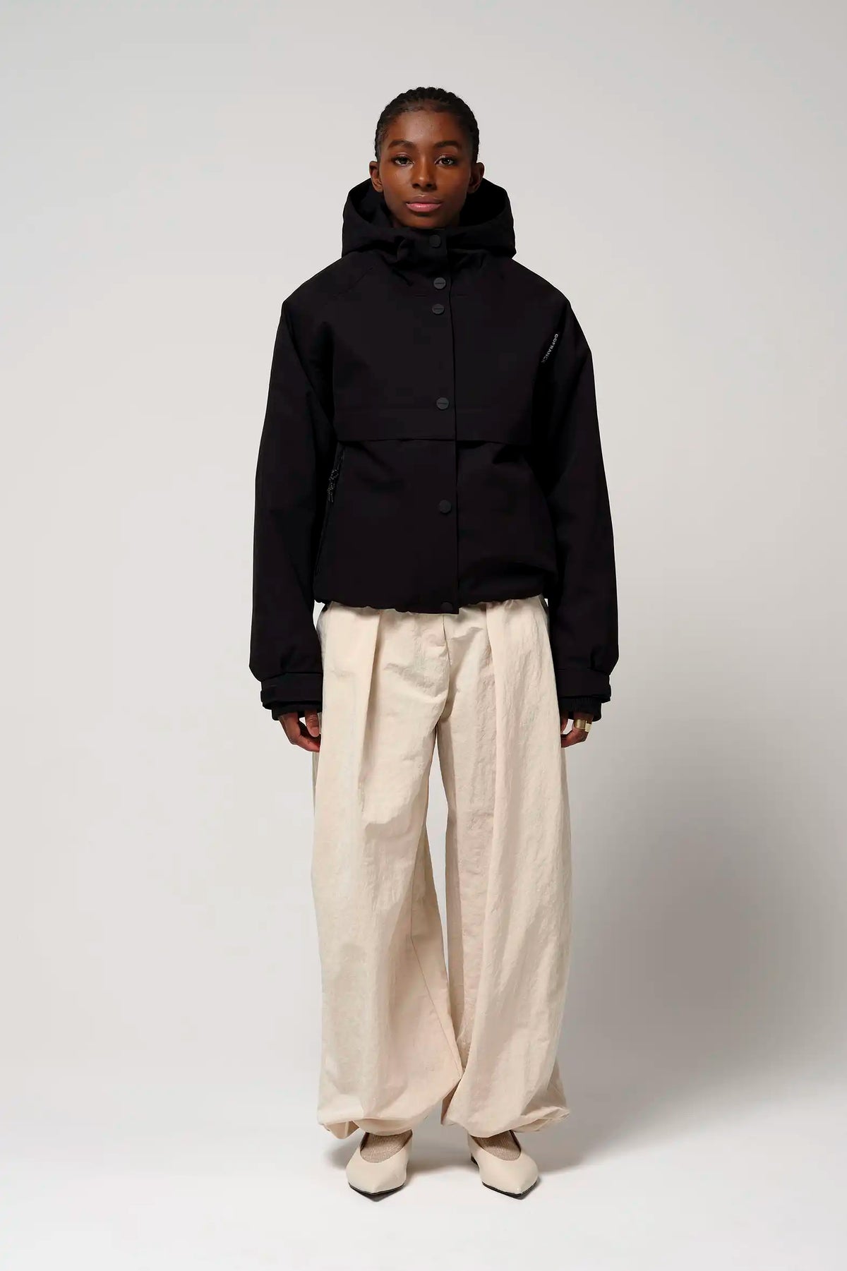 Guthrie Deep Black Coat worn by model with casual style, showcasing waterproof and windproof features.