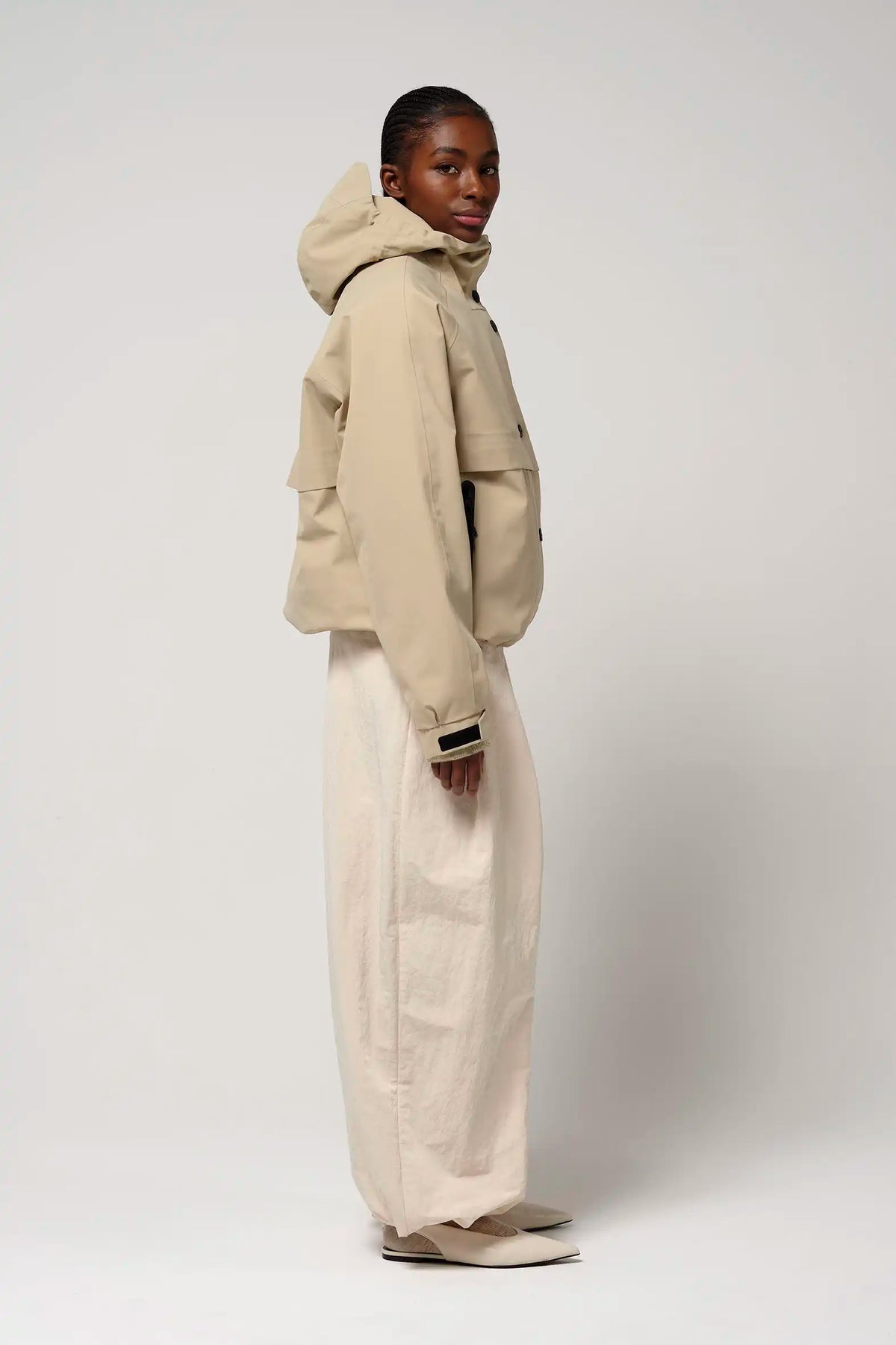 Guthrie Fields of Rye Beige Coat on model, showcasing waterproof, breathable features and adjustable hood.