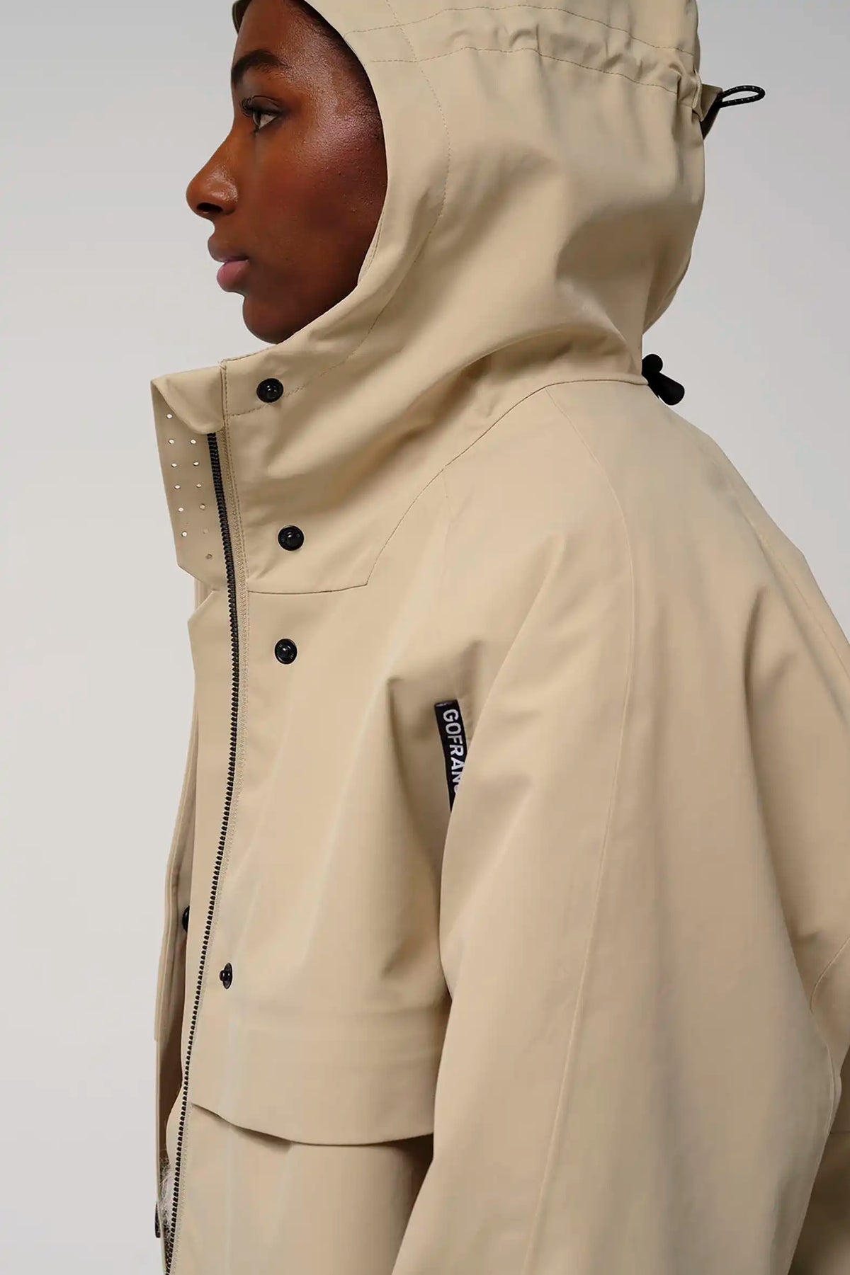 Guthrie Fields of Rye Beige Coat displayed on model side view, showcasing waterproof and breathable features.