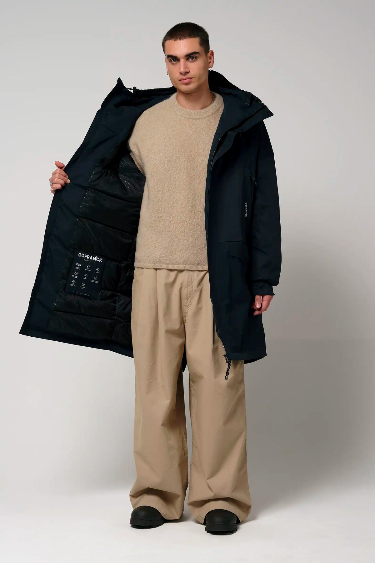 Stratus Sky Captain Blue Parka displayed by a model, showcasing its interior features and windproof design.