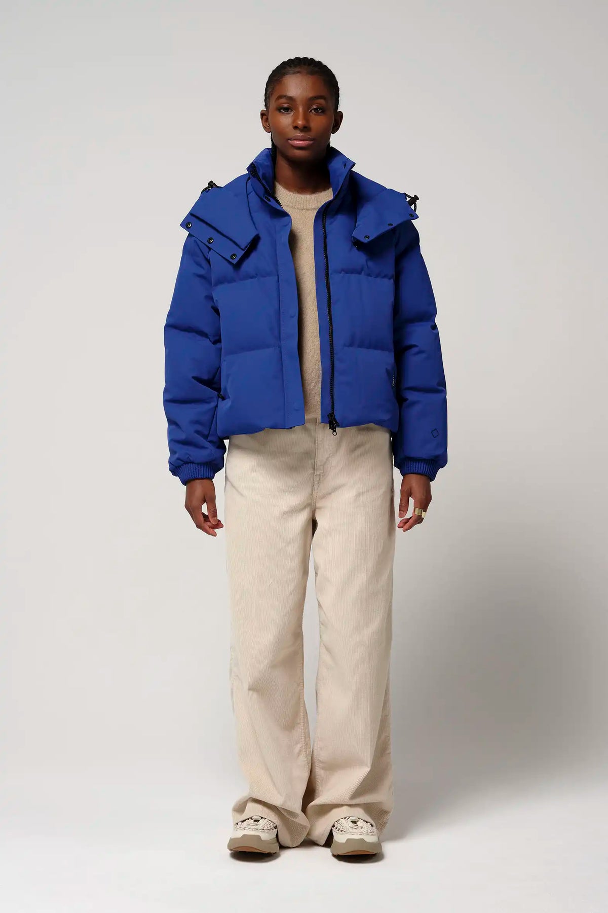 Talon Sodalite Blue Coat displayed by model, showcasing waterproof and windproof features.