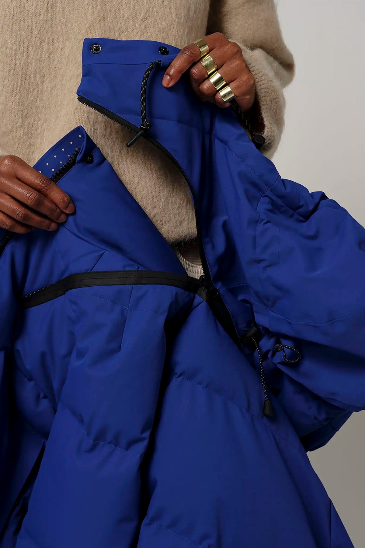 Talon Sodalite Blue Coat showing details like adjustable hood and two-way zipper, perfect for winter weather.