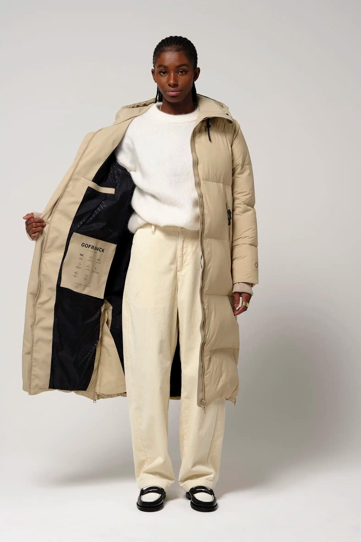 Model wearing the Tsunami Fields of Rye Beige Coat, showcasing its lightweight and stylish design.