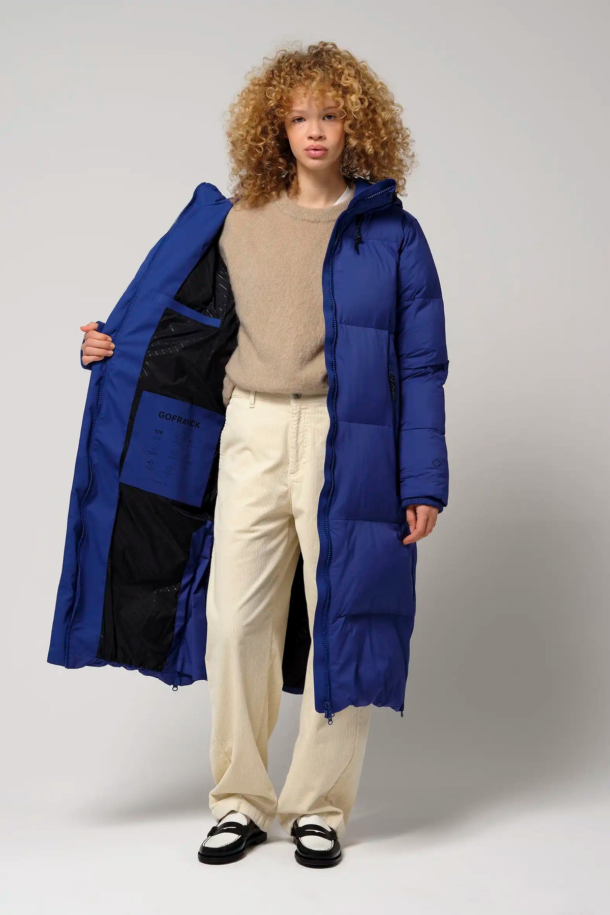 Model wearing Tsunami Sodalite Blue Coat with open front, showcasing its lightweight design and vibrant blue color.