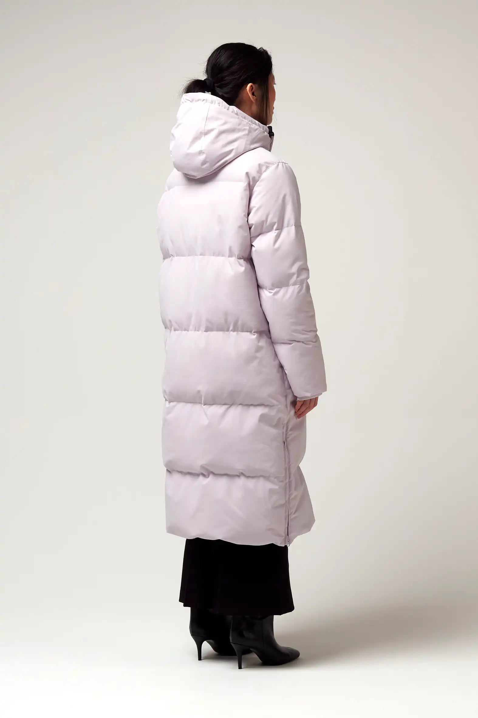 Tsunami Lilac Orchid Coat featured in a light lilac color, showcasing its puffer design and hood from the back.