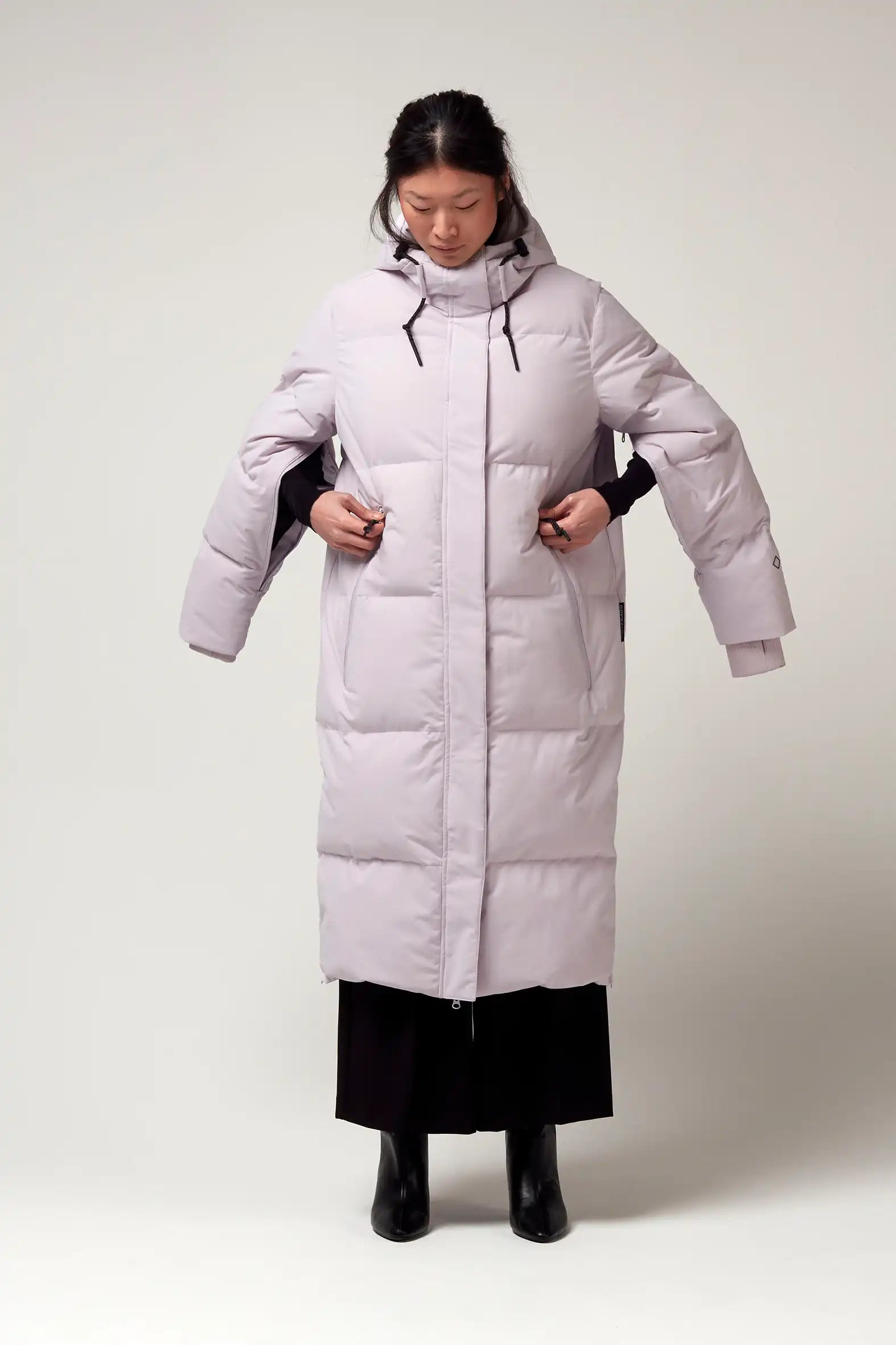Model wearing Tsunami Lilac Orchid Coat, showcasing its lightweight design and stylish puffer silhouette.