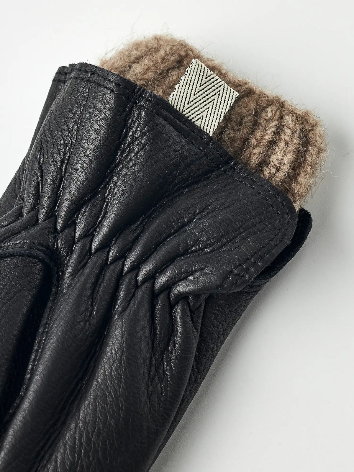 Tiril Black Gloves by Hestra featuring supple deerskin leather and soft wool lining for warmth and comfort.