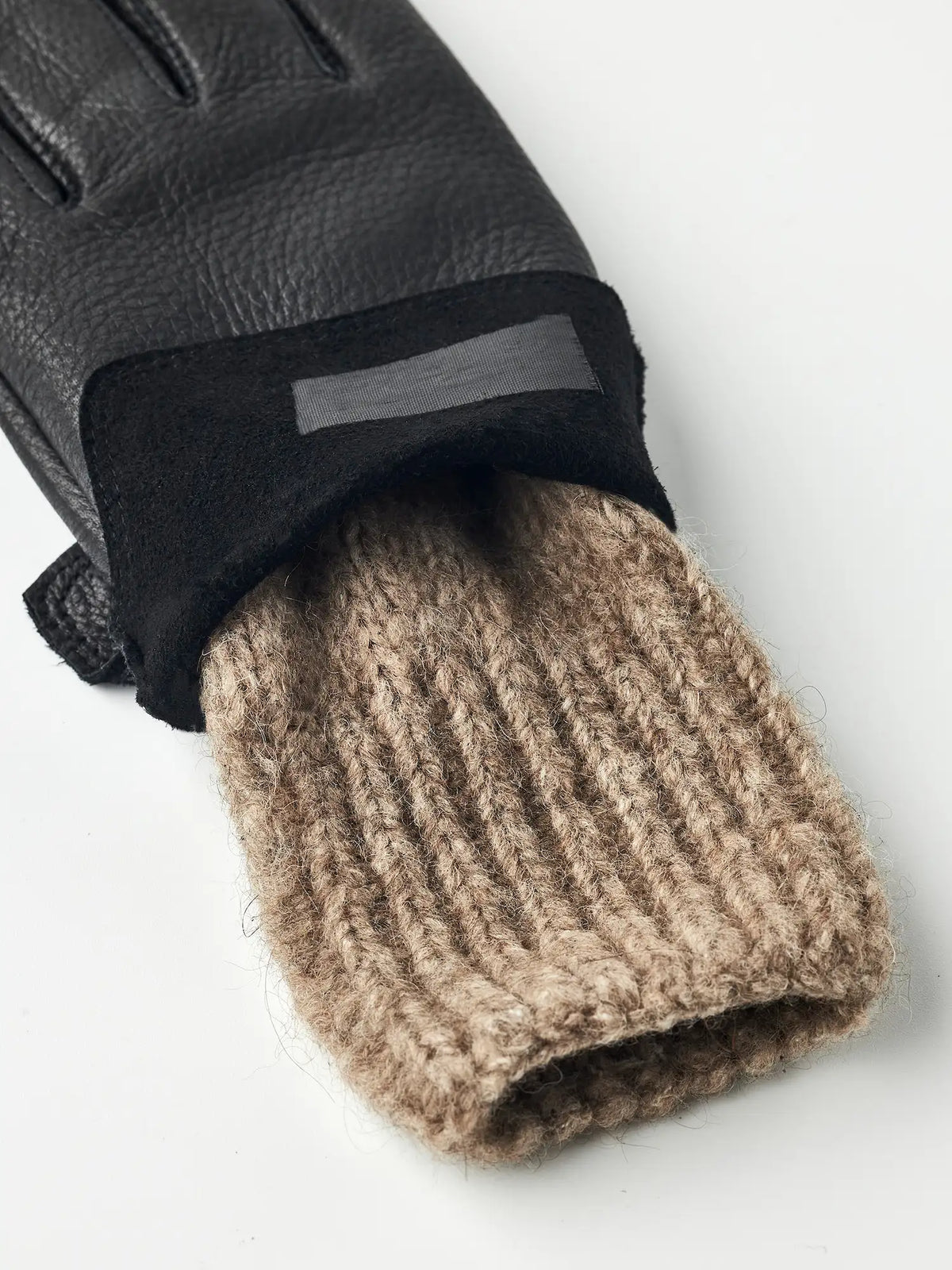 Tiril Black Gloves featuring supple deerskin leather and warm wool lining by Hestra, perfect for cold weather.