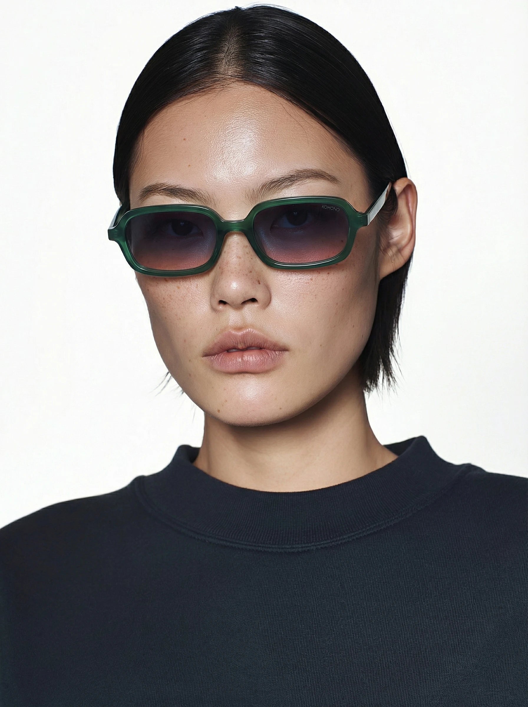 Hayden Green Jungle Sunglasses modeled by a person wearing dark clothing, featuring unique eco-friendly design.