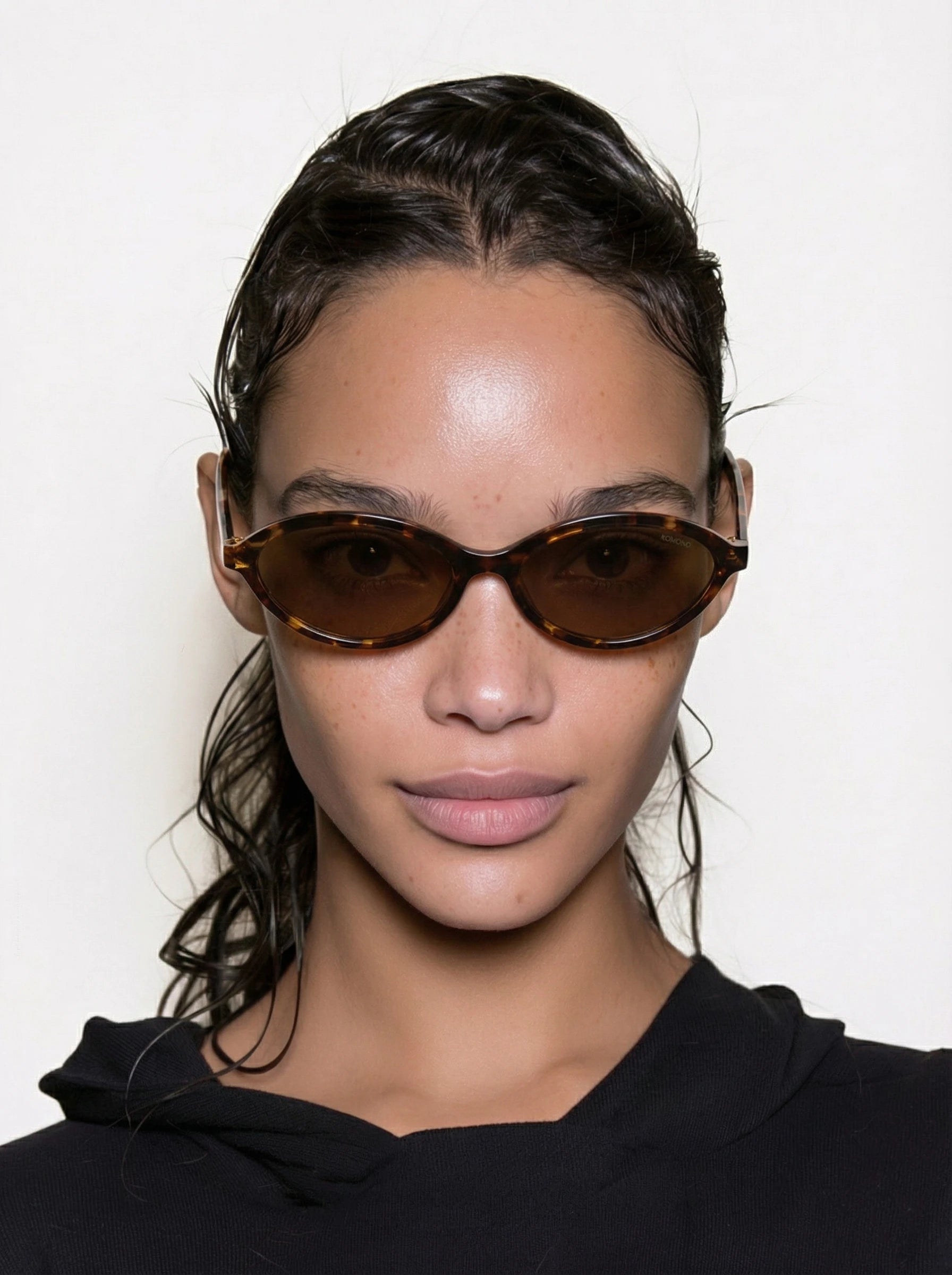 Doris Havana Amber Sunglasses worn by a model with a sleek hairstyle, featuring a stylish amber tortoiseshell design.