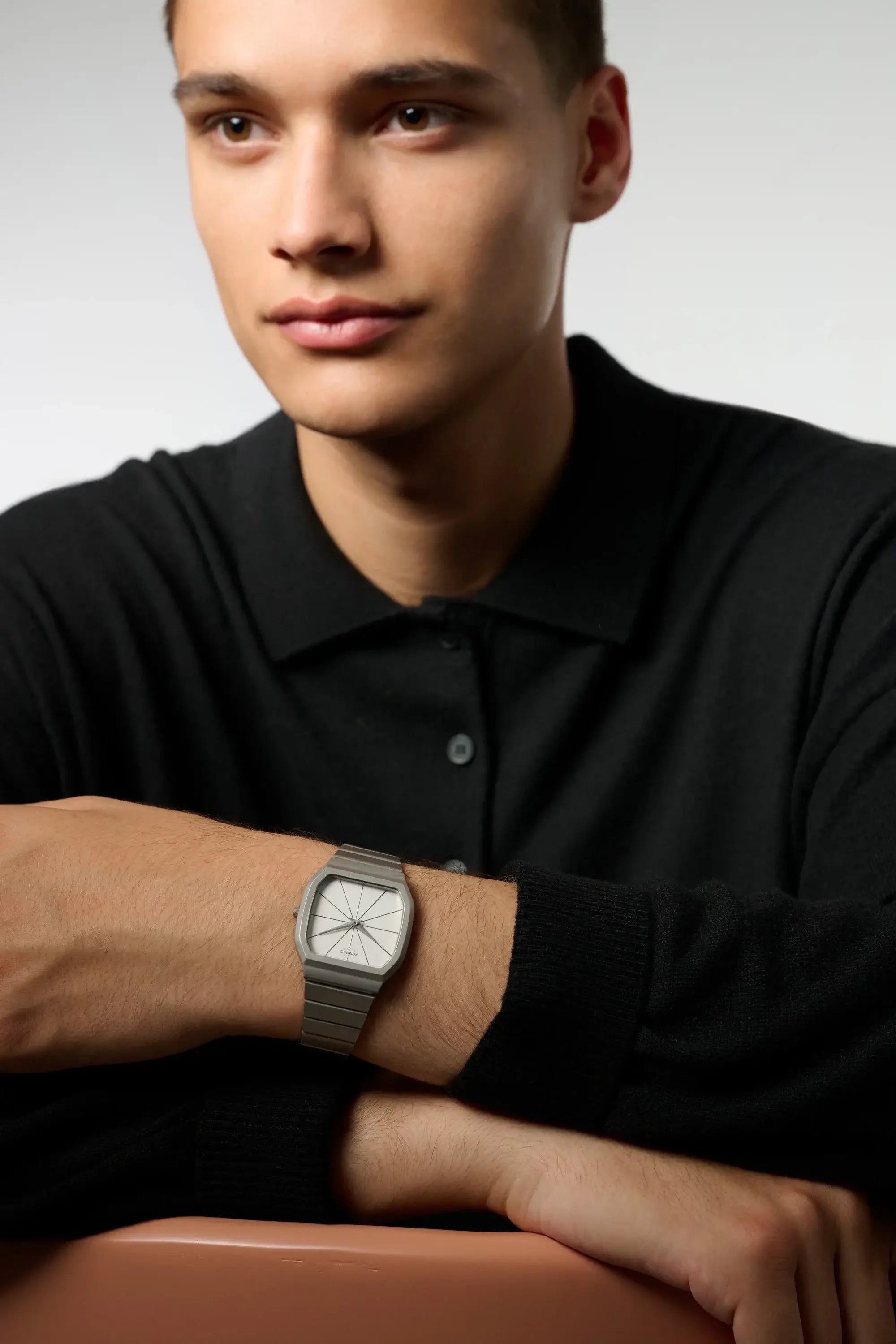 Max Silver Moon Watch displayed on model's wrist, showcasing its sleek design and stainless steel strap.