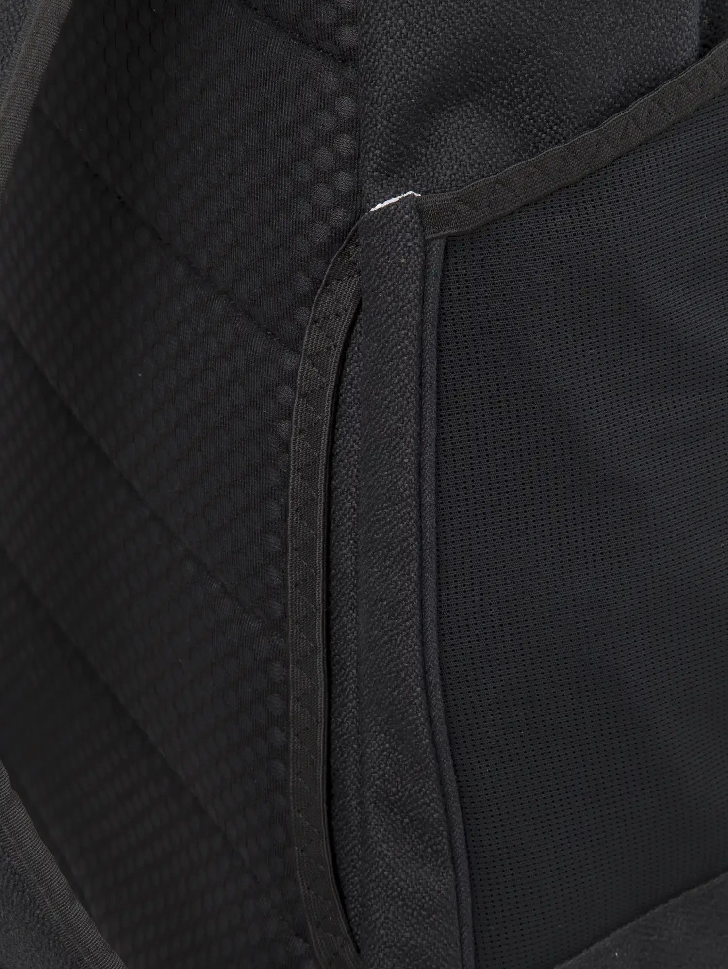 Interior view of Blok Large Licorice Black Backpack showcasing storage compartments and padded back panel.