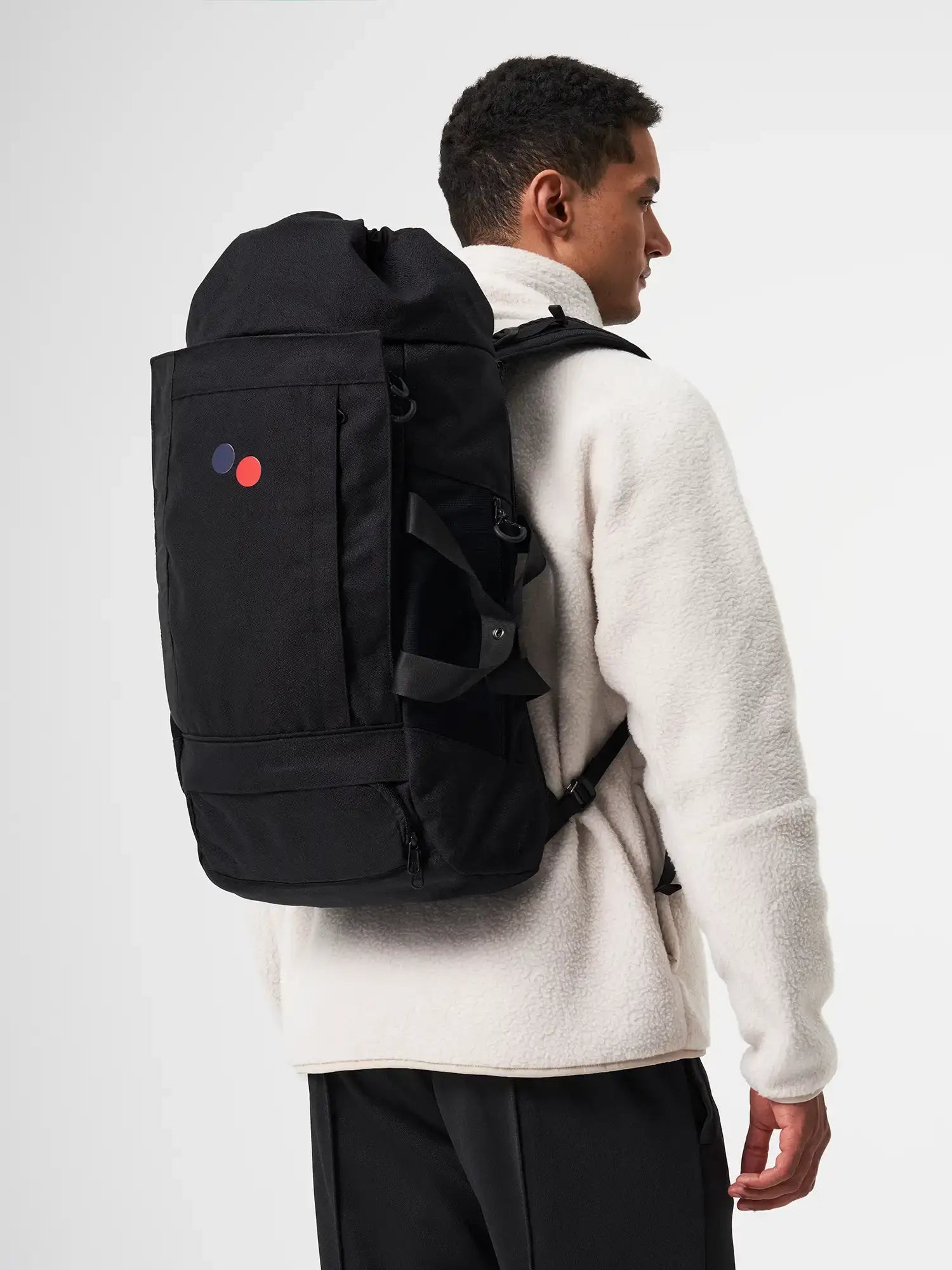 Blok Large Licorice Black Backpack worn on a model's back, showcasing its spacious design and stylish look.